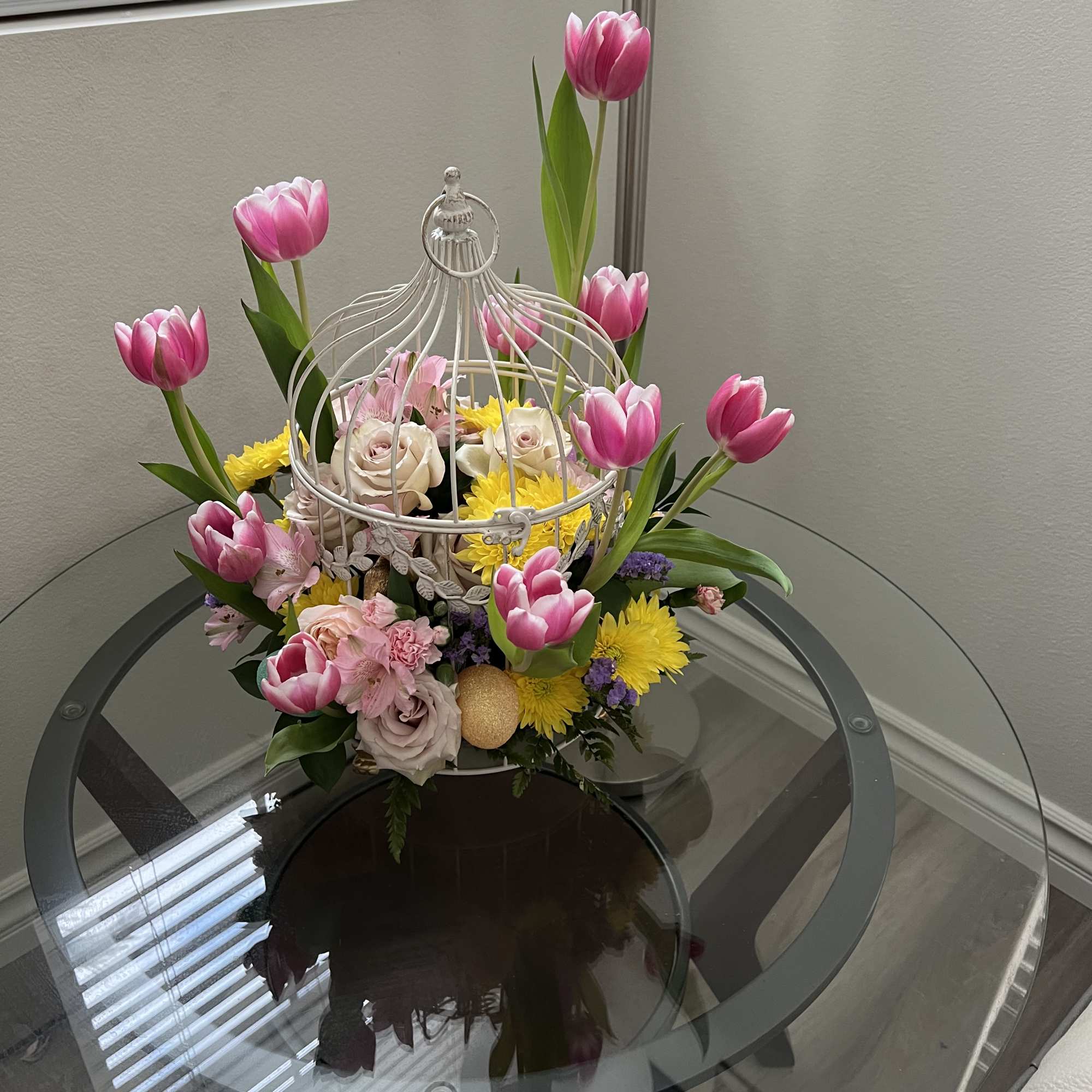 Pink tulips and mixed flowers arranged in a white birdcage centerpiece, photo 2 of 2