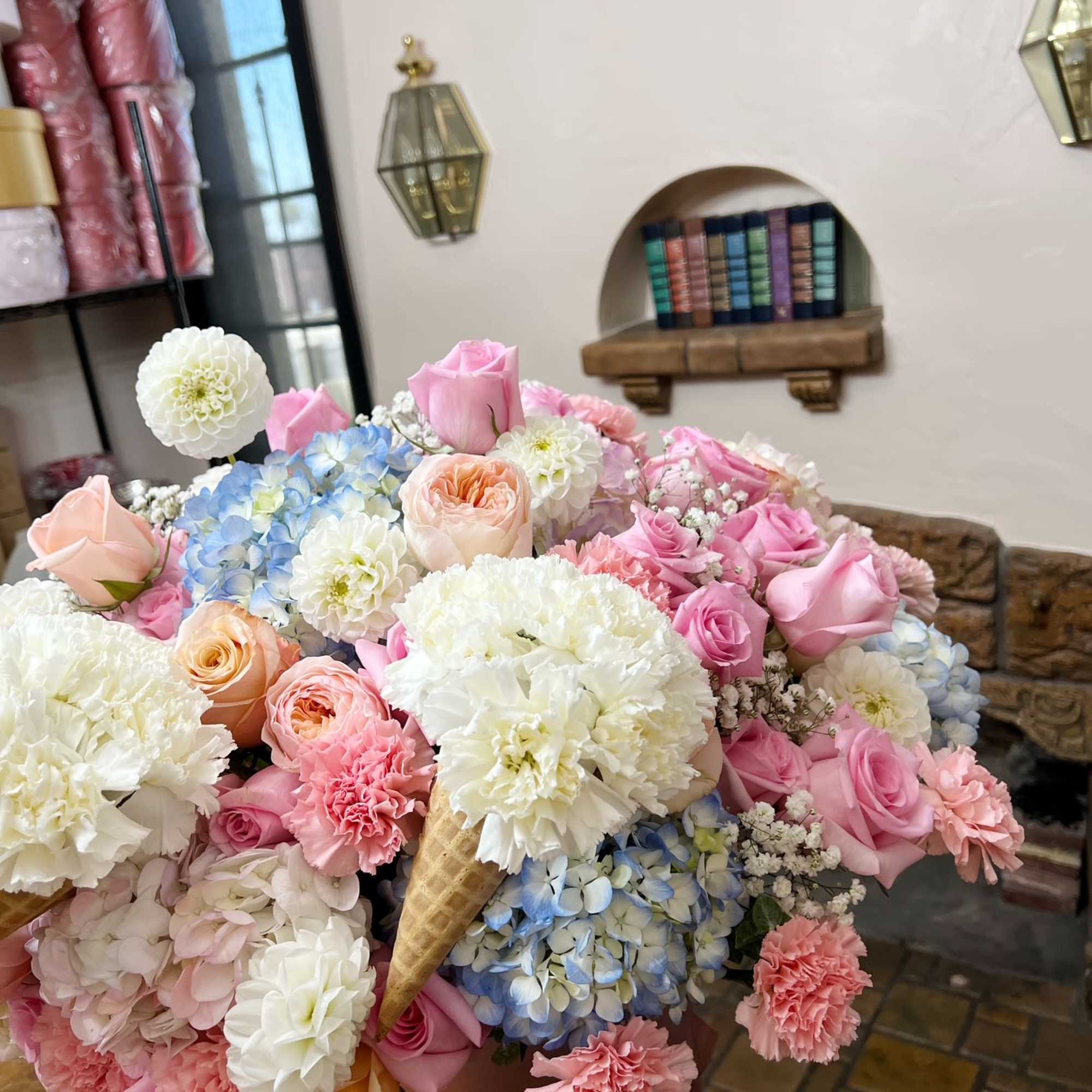 Large pastel bouquet with pink and white roses, hydrangeas, and carnations