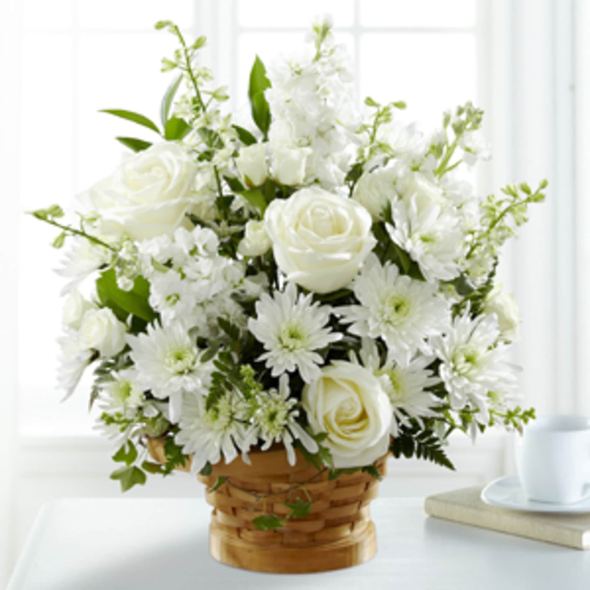White roses and daisies in a woven basket