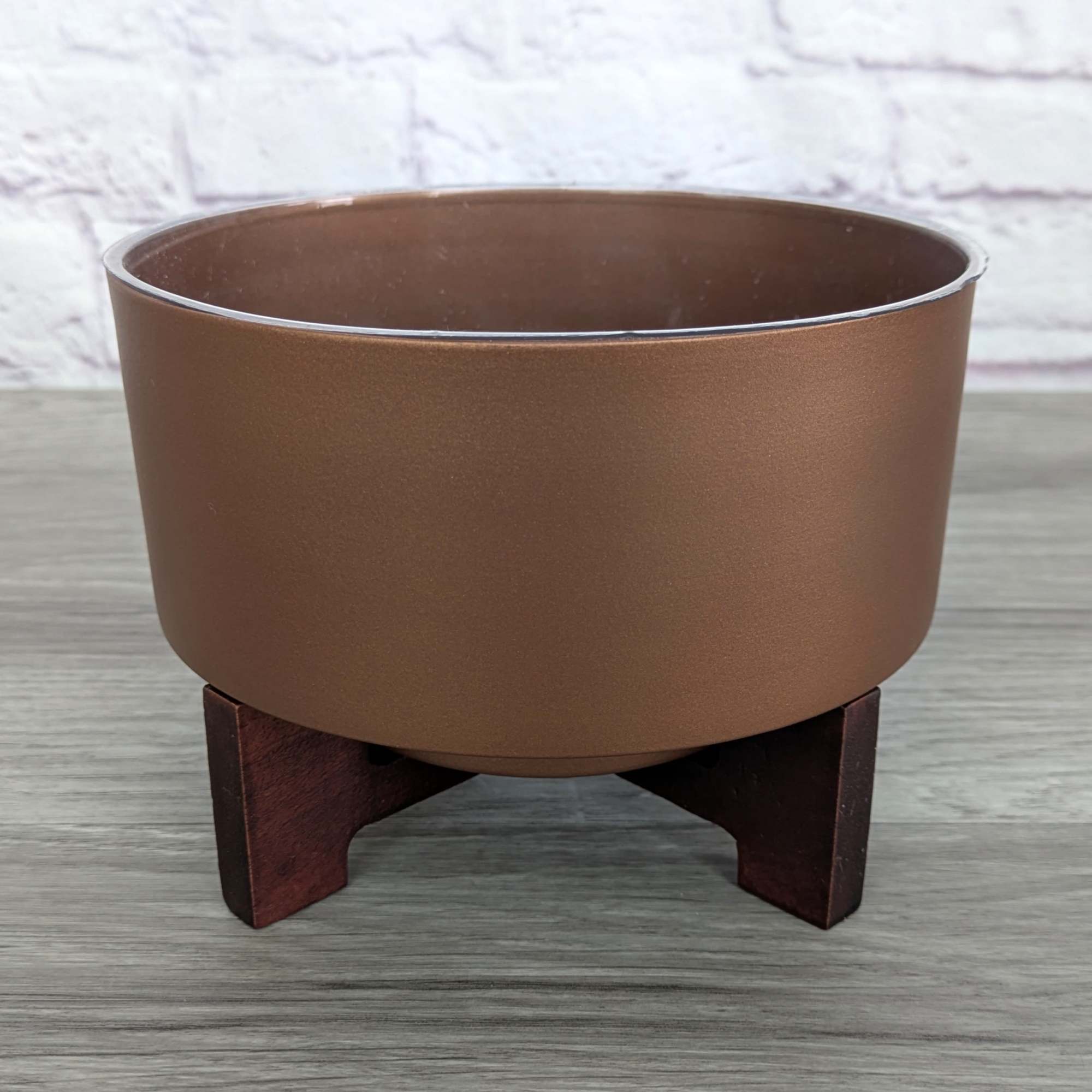Brown planter bowl on a small wooden stand