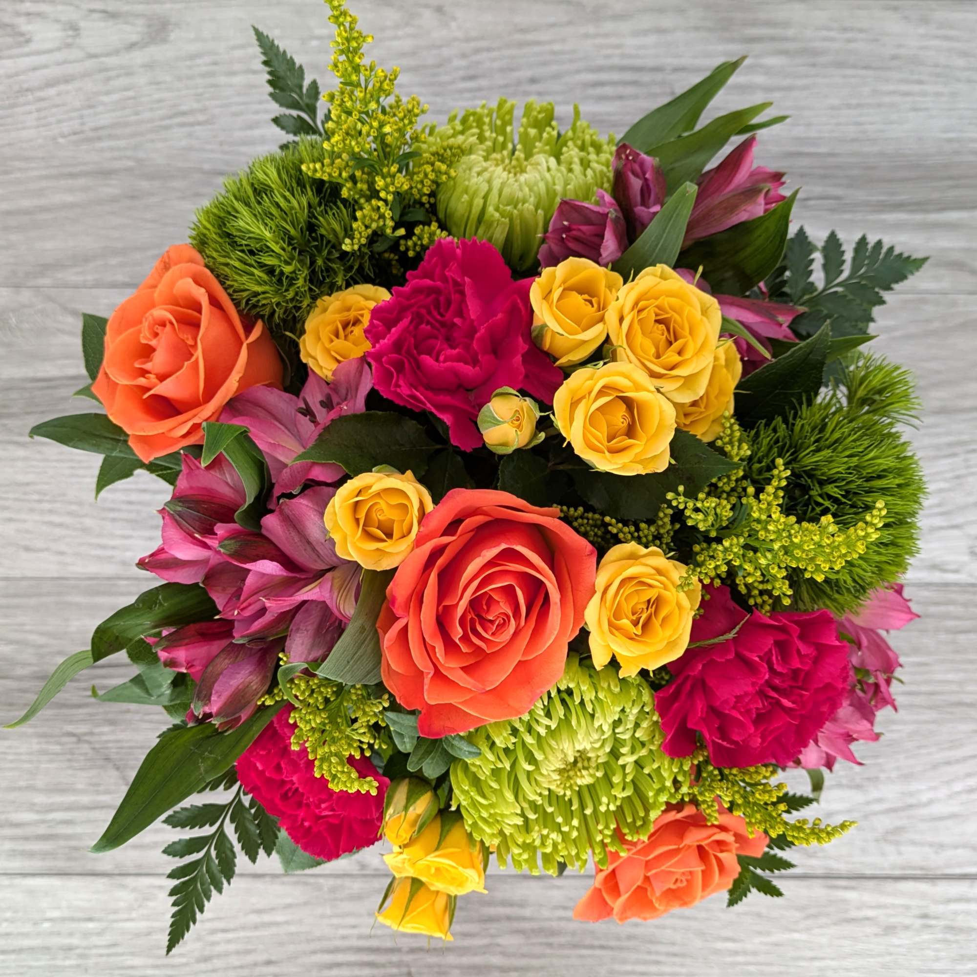 Bright mixed bouquet with roses, carnations, and green chrysanthemums