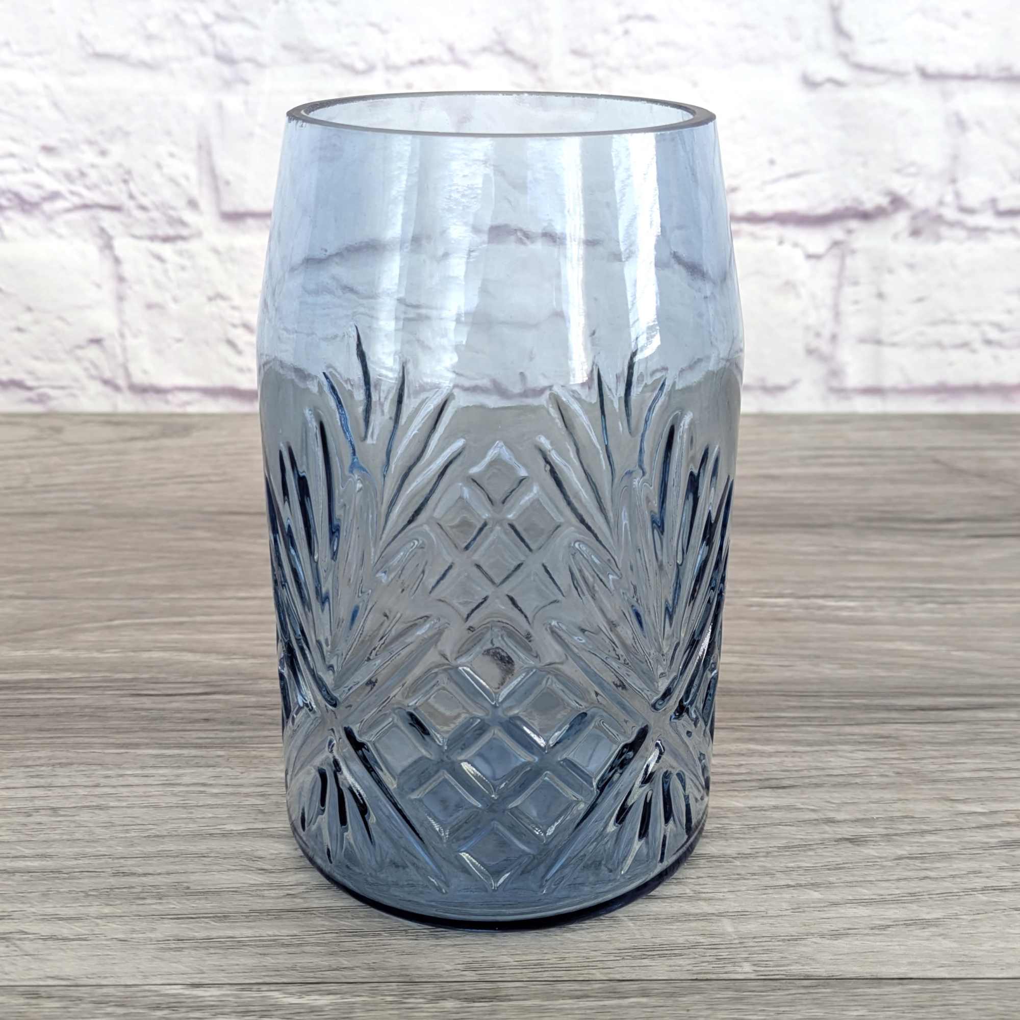 Blue-tinted glass vase with etched geometric pattern