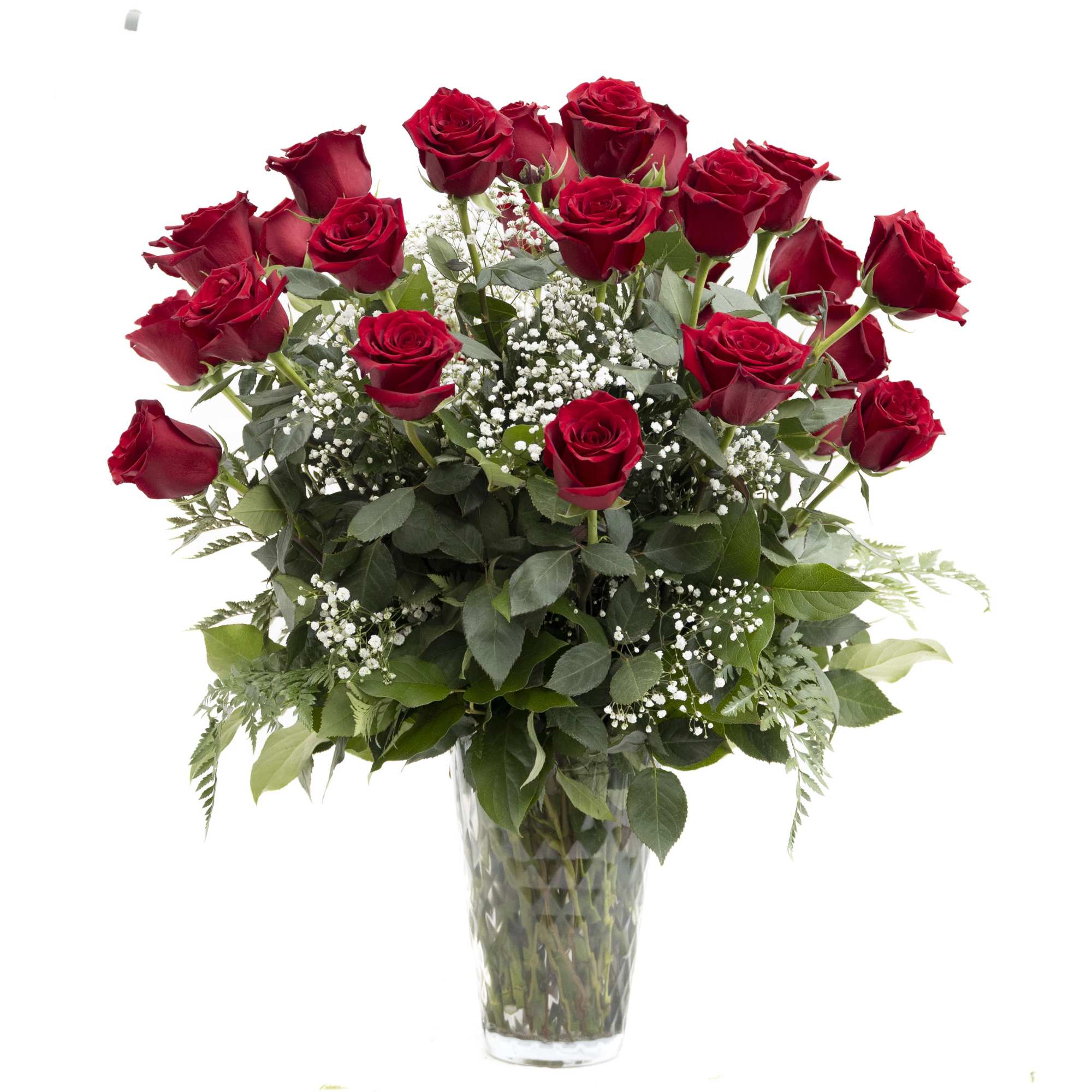 Red roses arranged in a clear glass vase with baby's breath