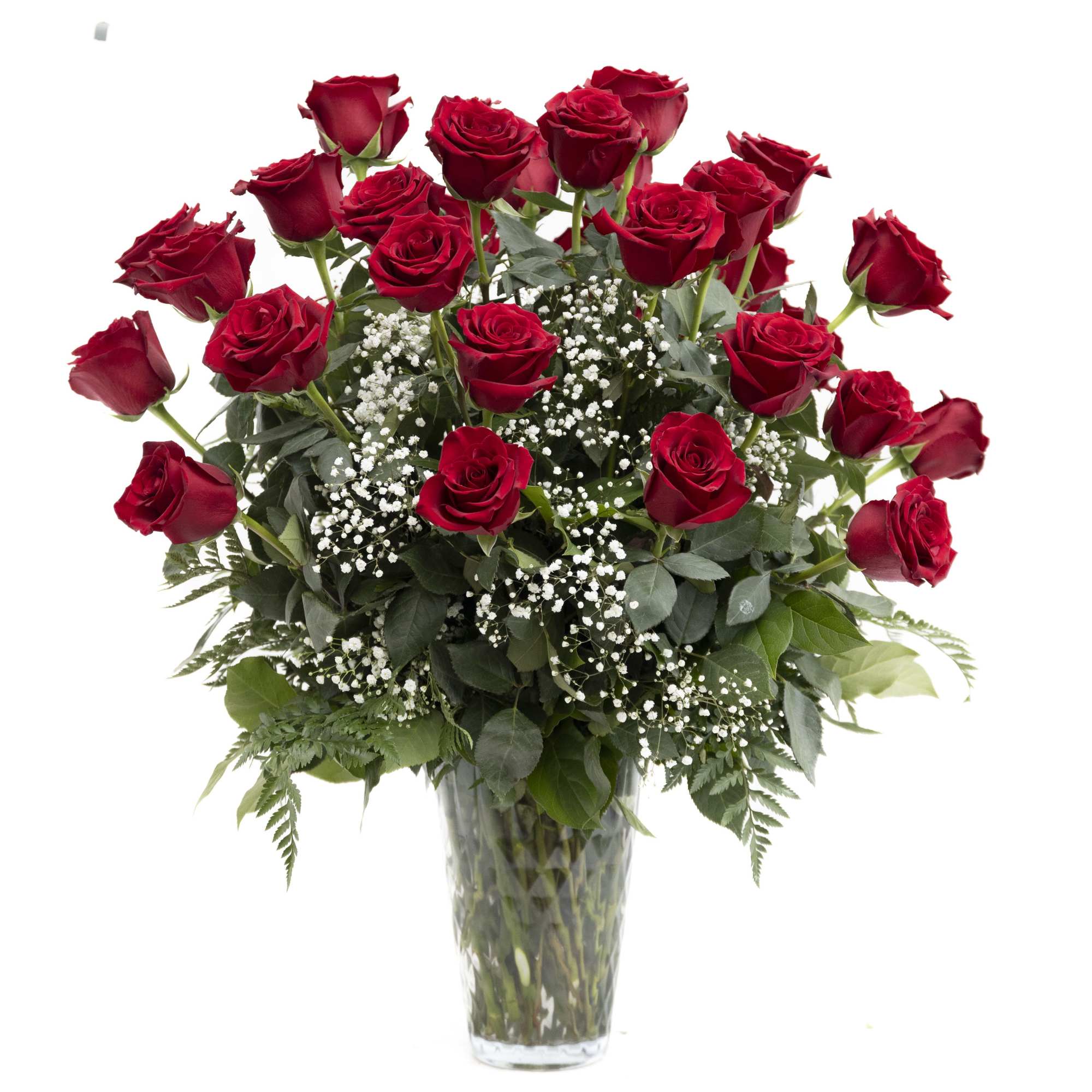 Red roses arranged in a clear glass vase with baby's breath