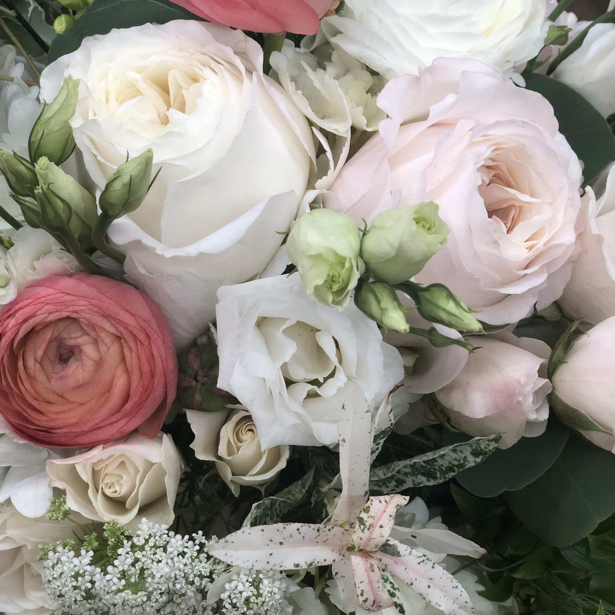 Bouquet of white and blush flowers with pink ranunculus and roses