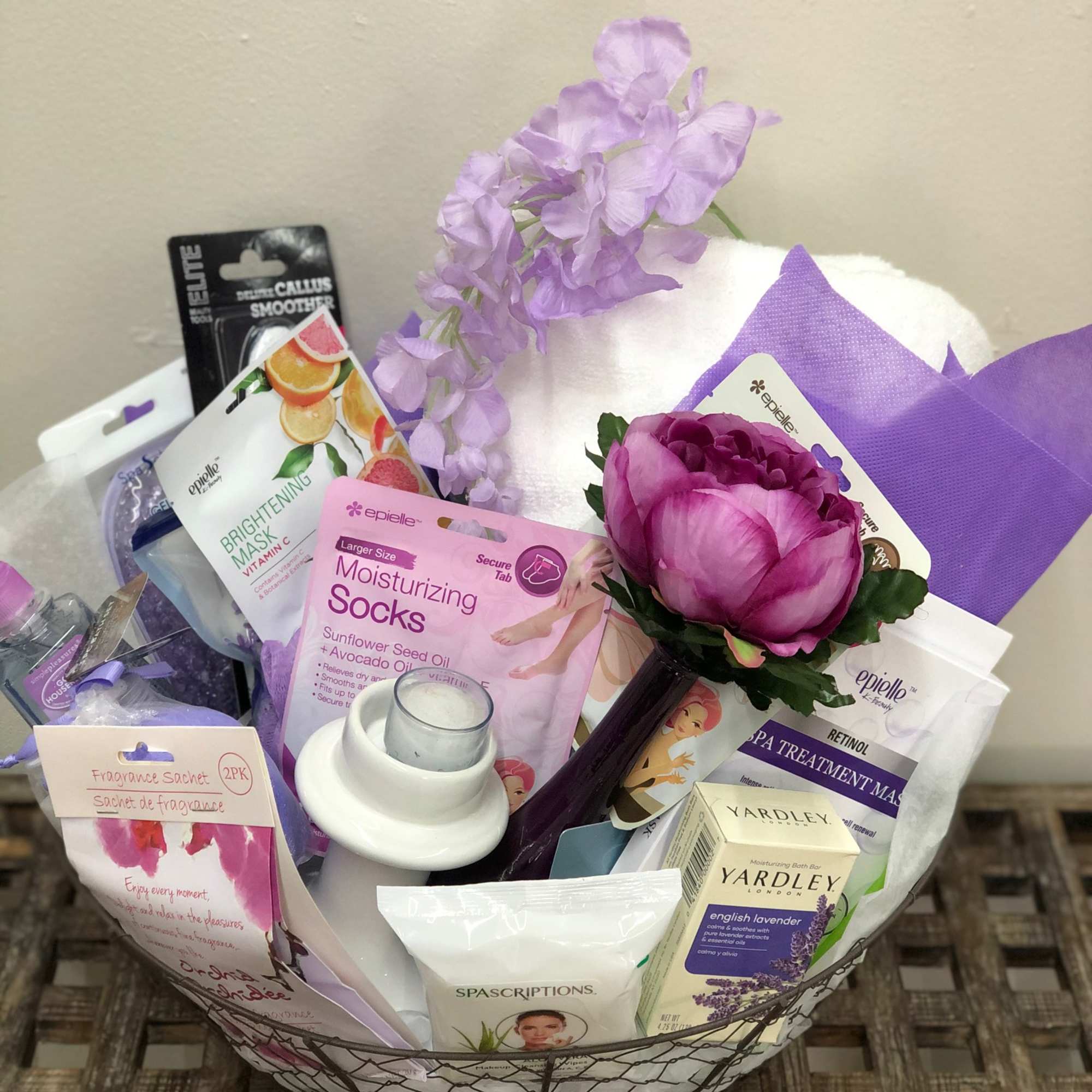 Spa gift basket with a purple flower and assorted bath products