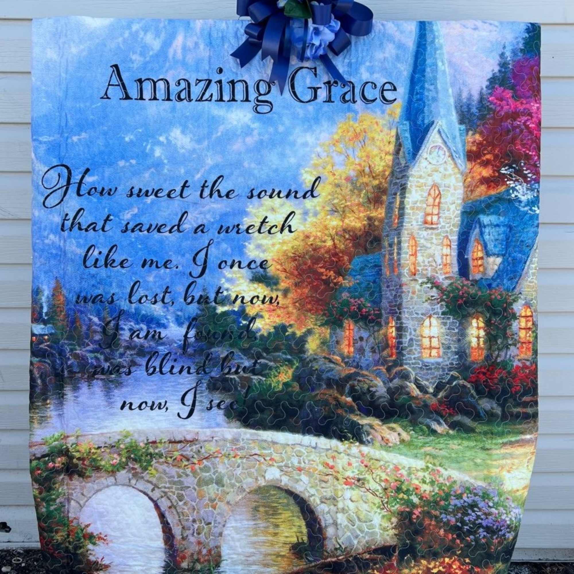 Decorative blanket with a church scene and "Amazing Grace" text