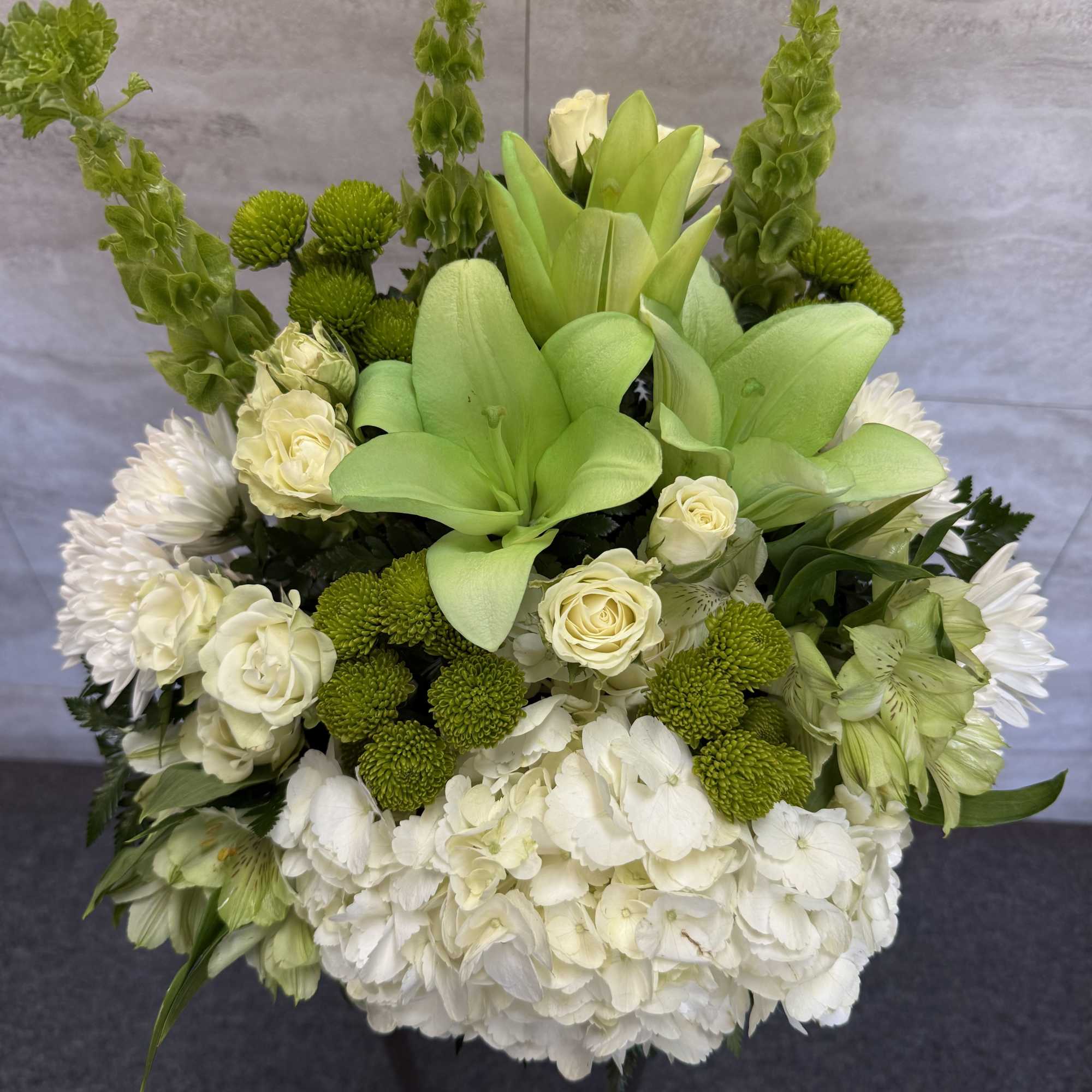 (ONE-SIDED) A mix of flowers of green and white giving the looks