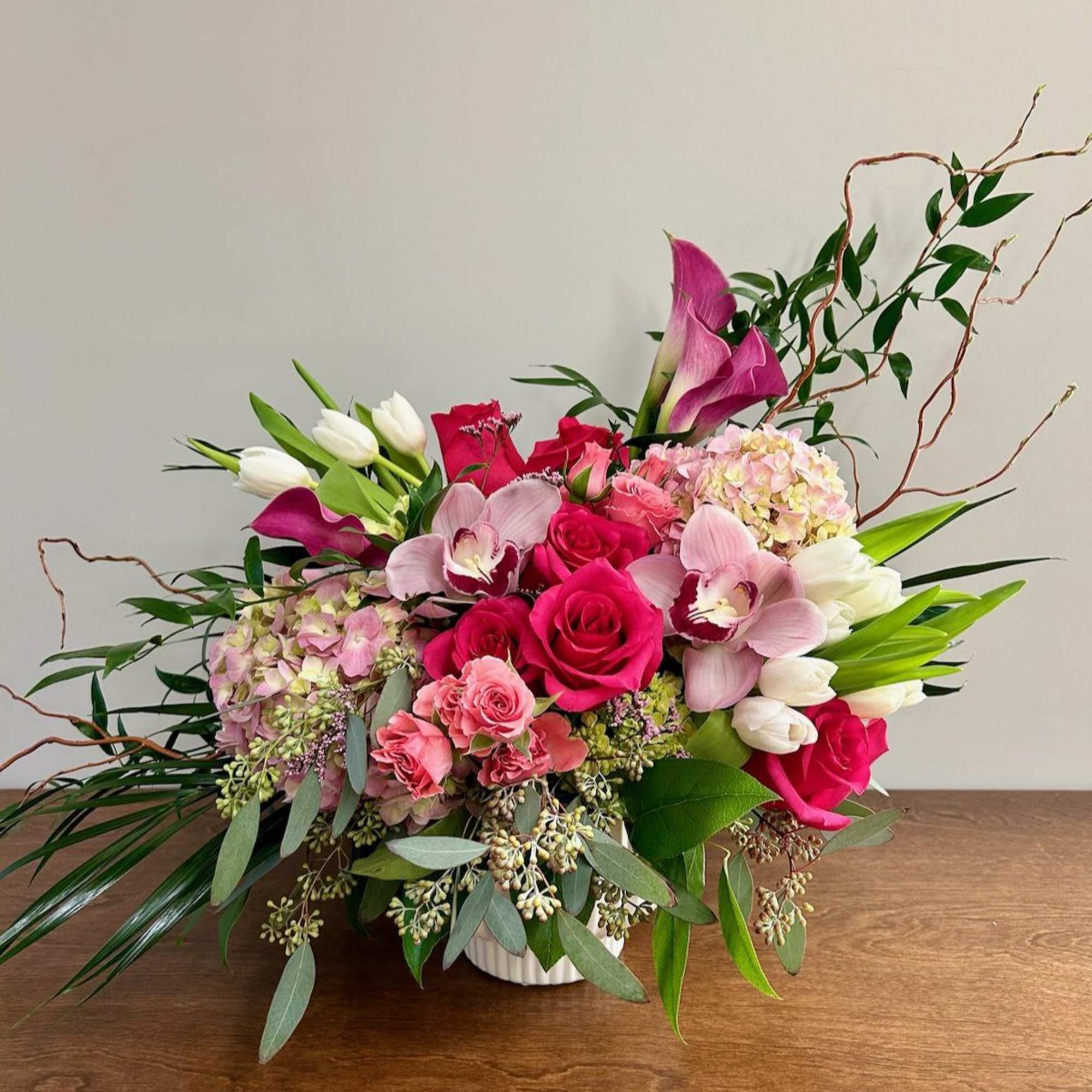 Pink and white floral arrangement in a white vase