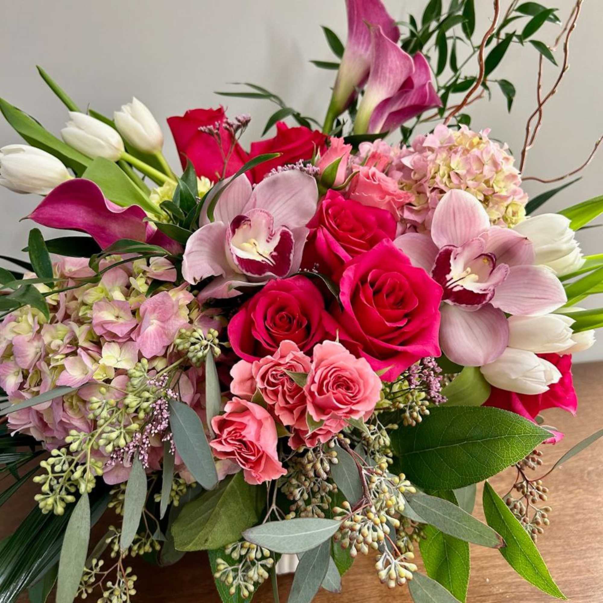 Bouquet of pink roses, calla lilies, orchids, and white tulips