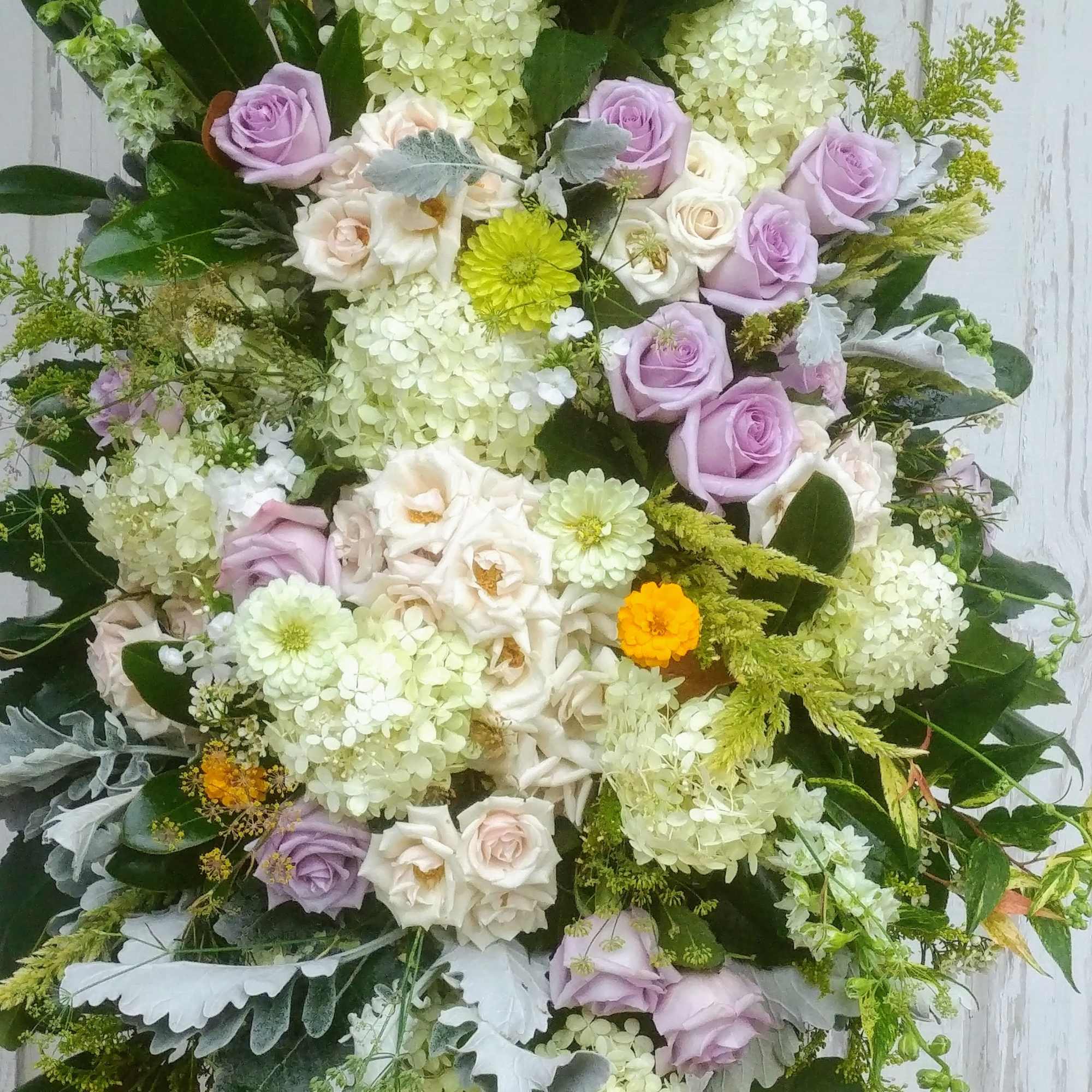 Large bouquet of lavender and white roses with pale hydrangeas