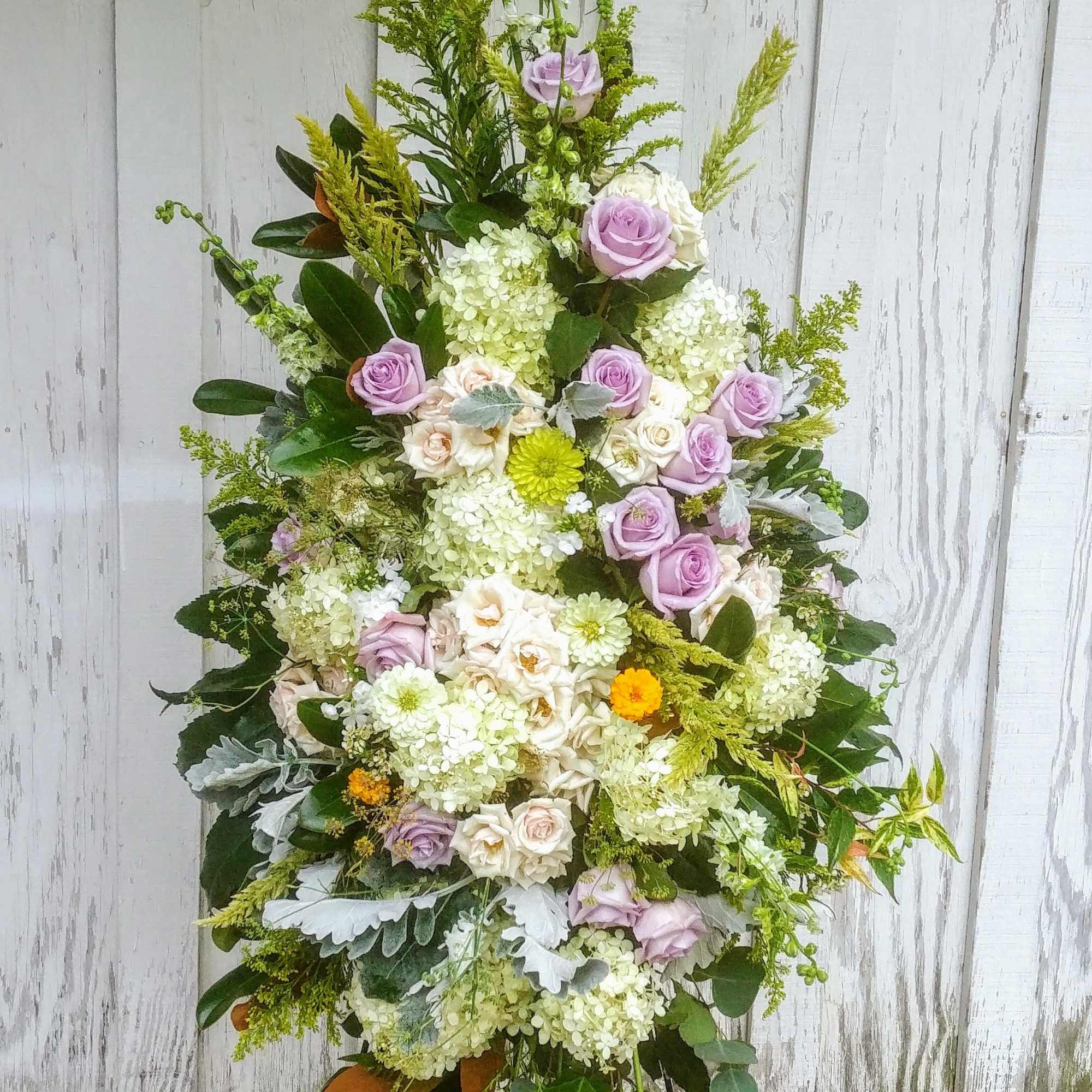 Tall floral standing spray with lavender roses and white blooms