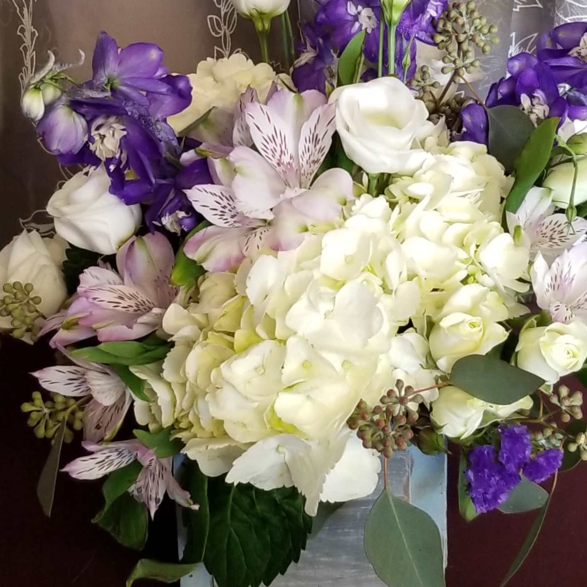 Designed in a 4"&times;4" wooden cube with hydrangea, alstromeria, lisianthus, delphinium, spray