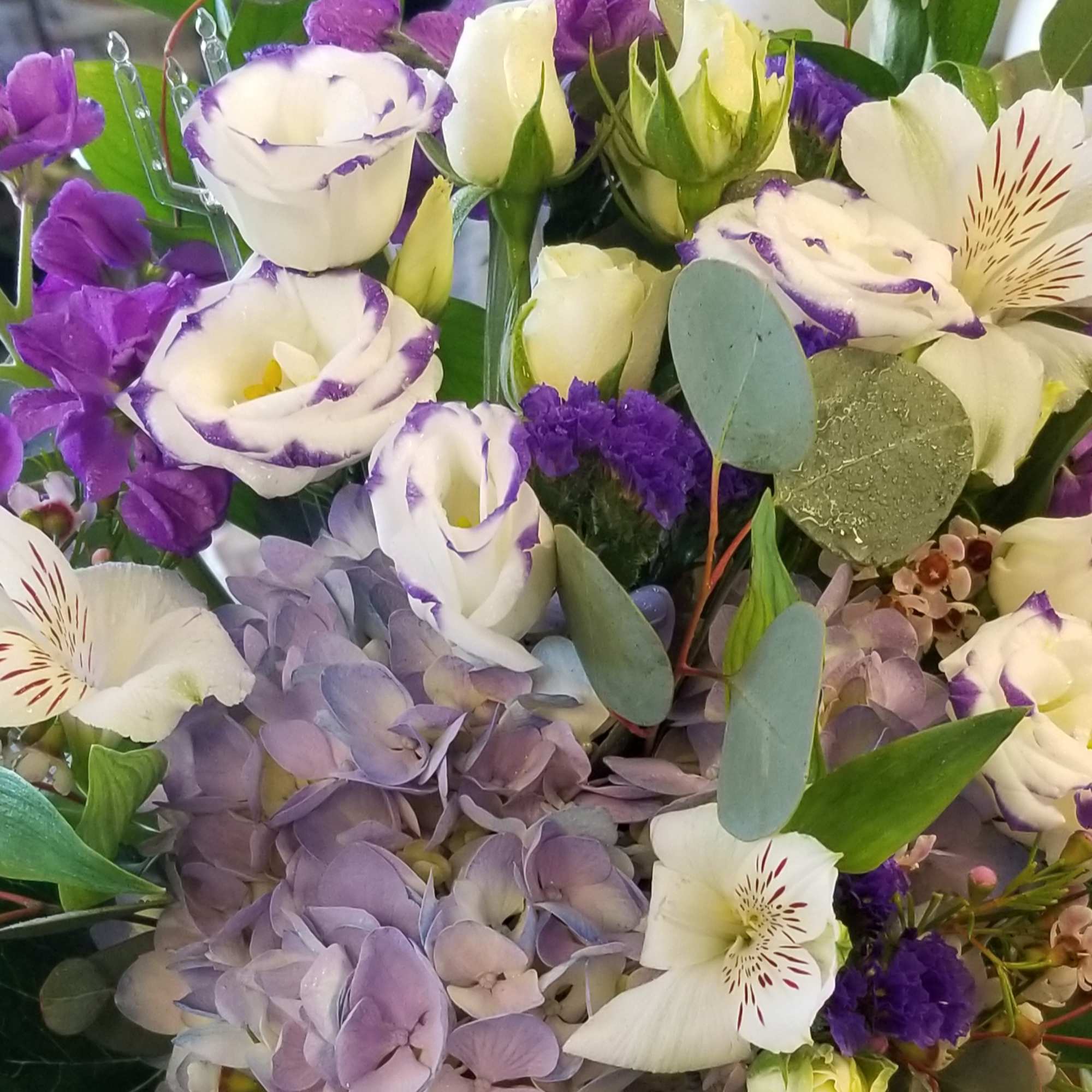 Bouquet of white and purple flowers with lavender hydrangea