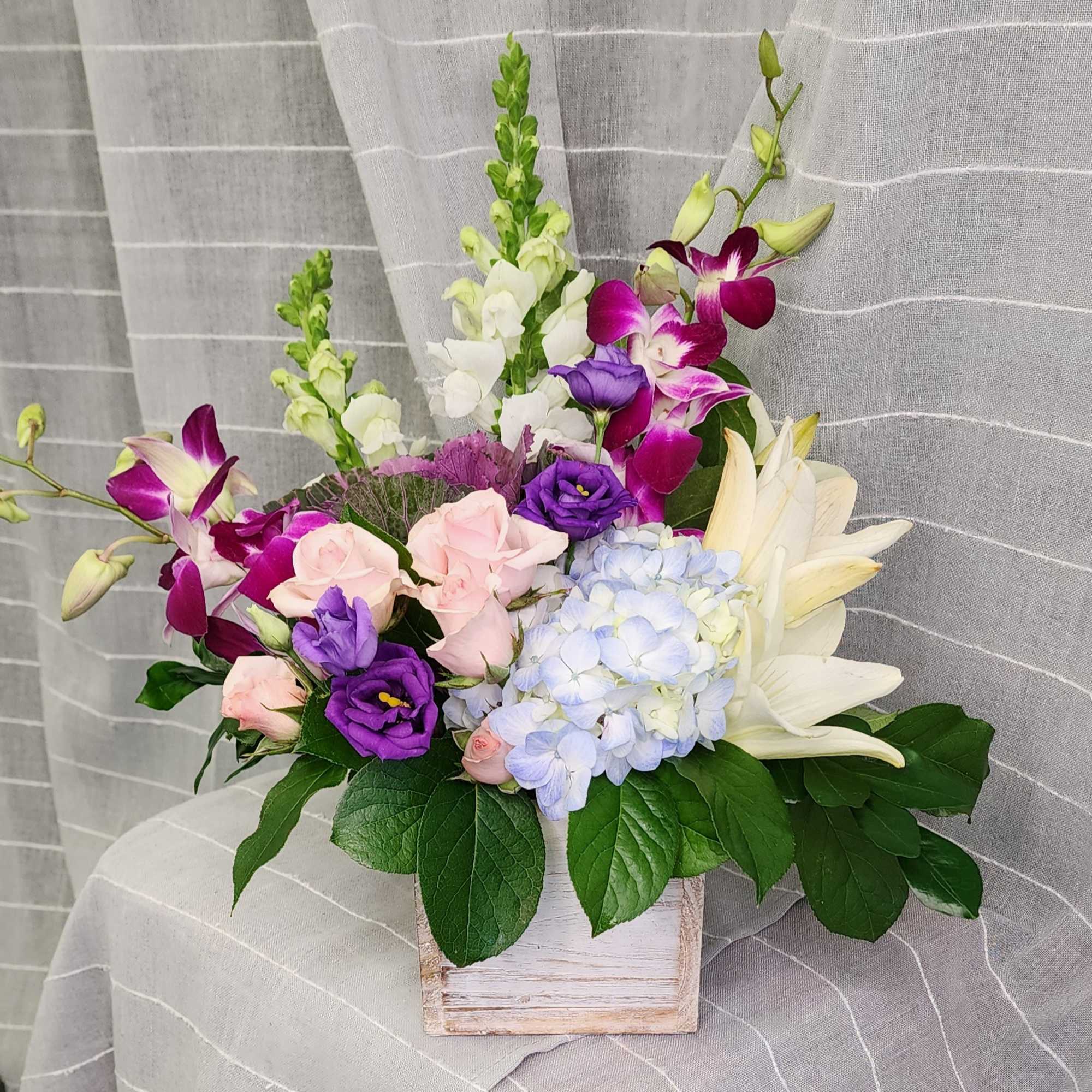 A beautiful array of dendrobium orchids, lilies, spray roses,  lisianthus, snapdragons, photo 2 of 3