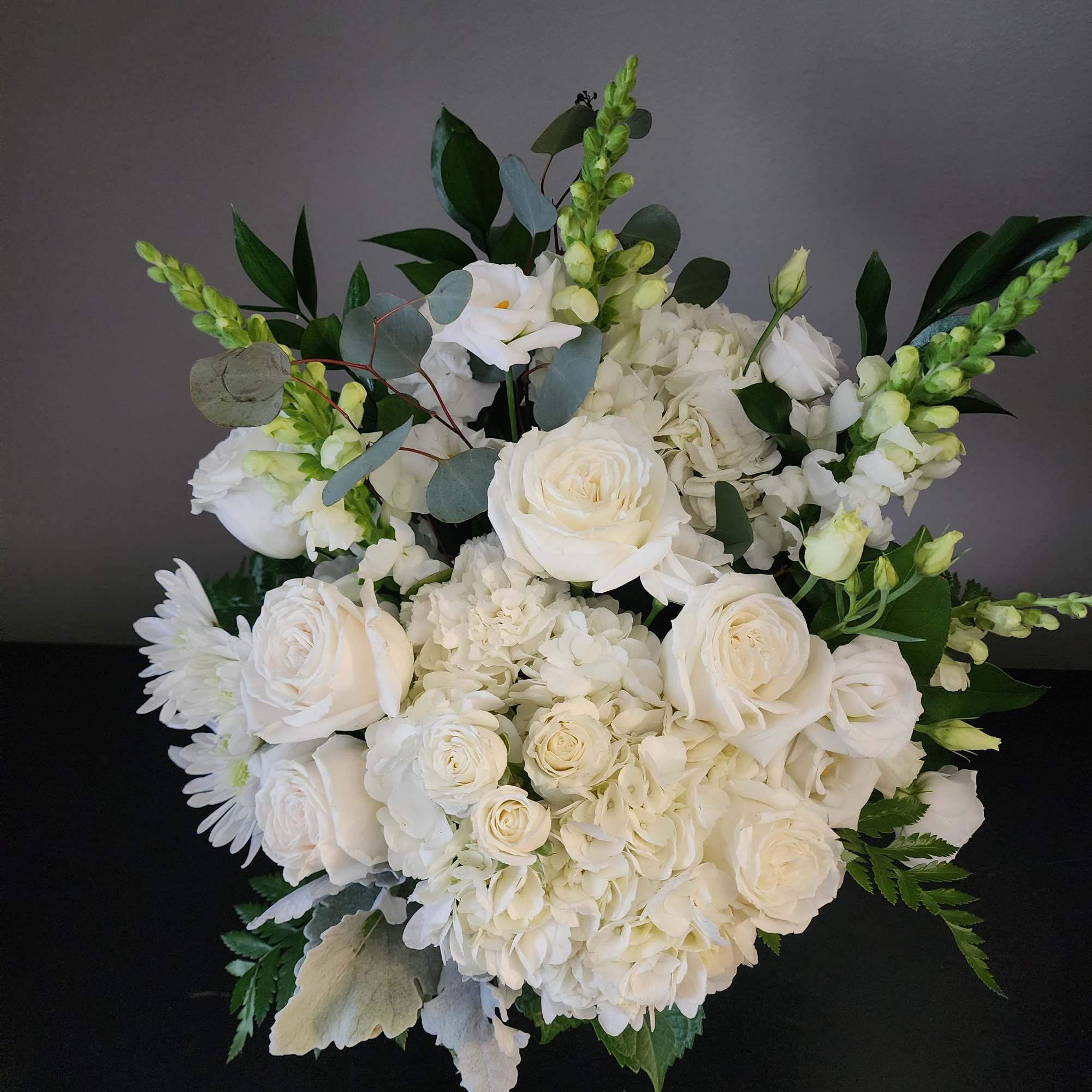 White rose and hydrangea bouquet with green foliage