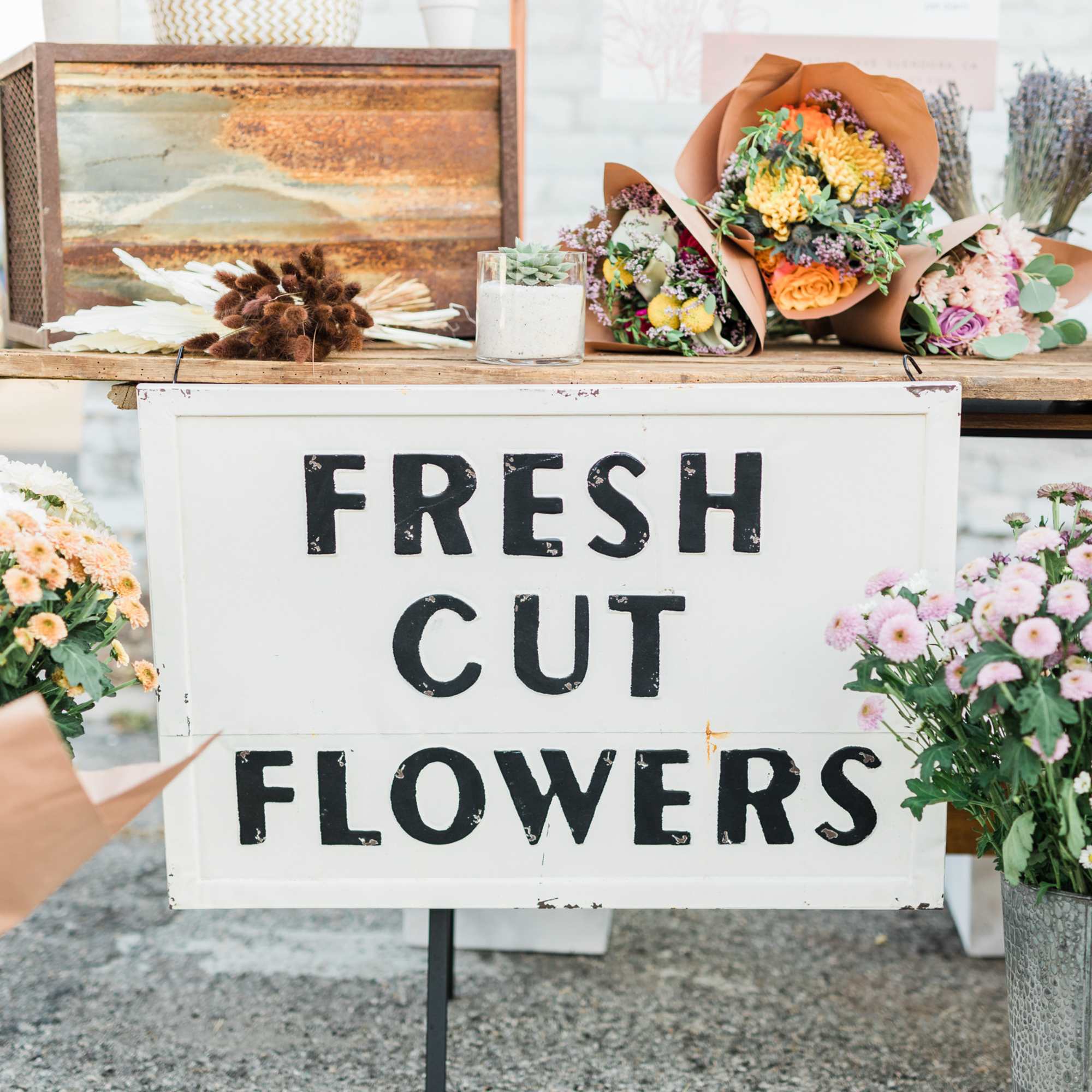 Flower market display with bouquets and a "Fresh Cut Flowers" sign