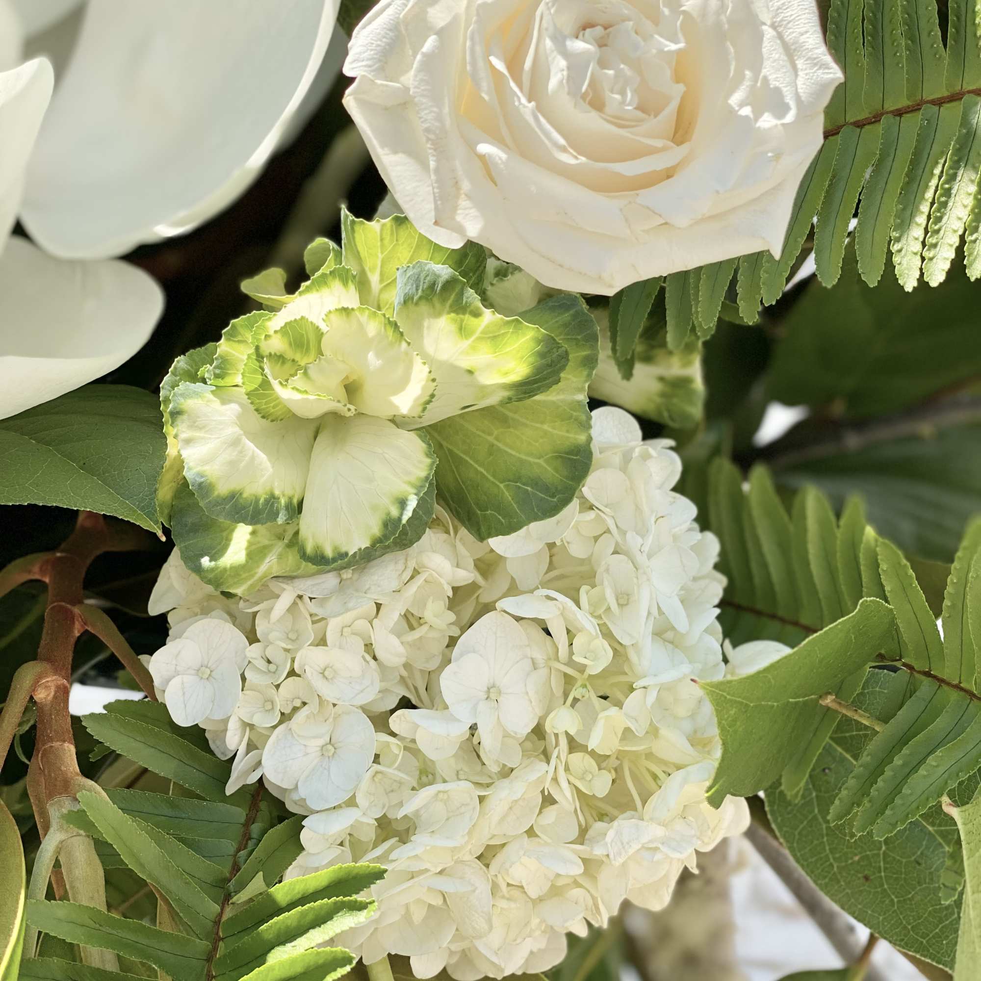 White rose and hydrangea bouquet with green foliage