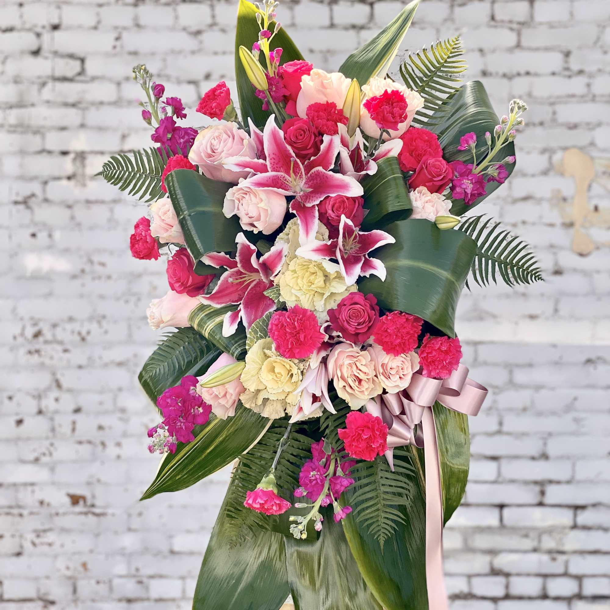 Pink and cream floral standing arrangement with lilies and roses