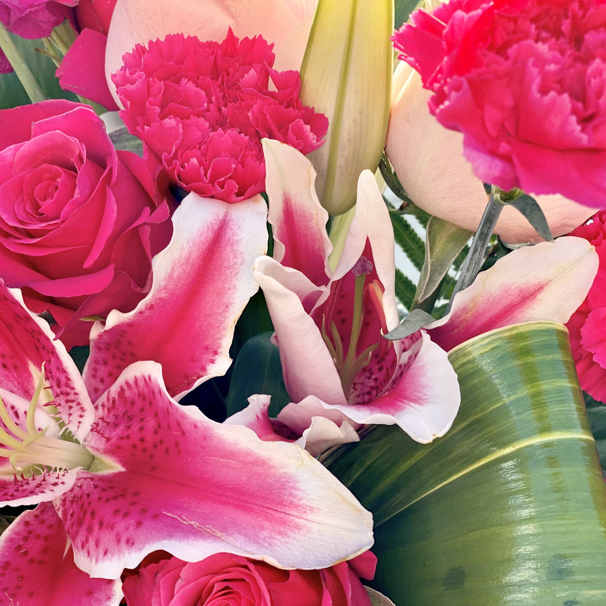 Bouquet of hot pink roses, carnations, and lilies