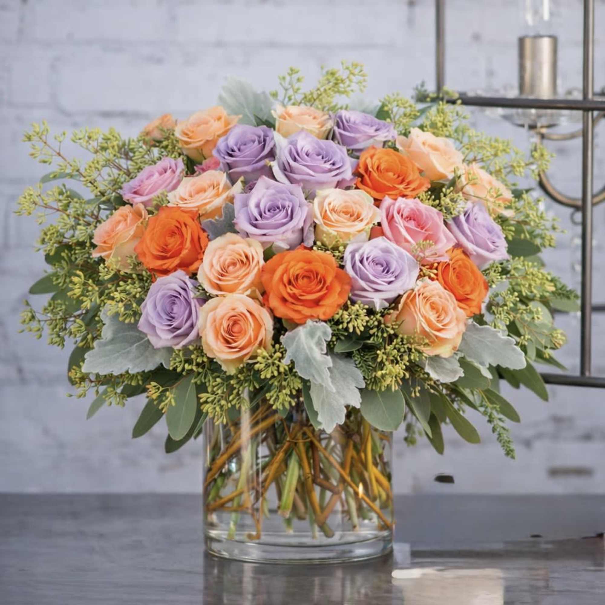 Bouquet of pastel roses in a clear glass vase