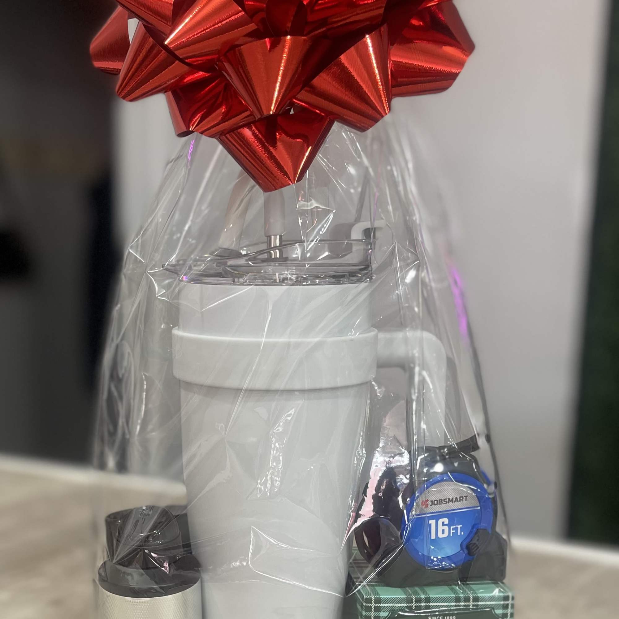 A bold metallic red bow tops a casually handsome gift set designed