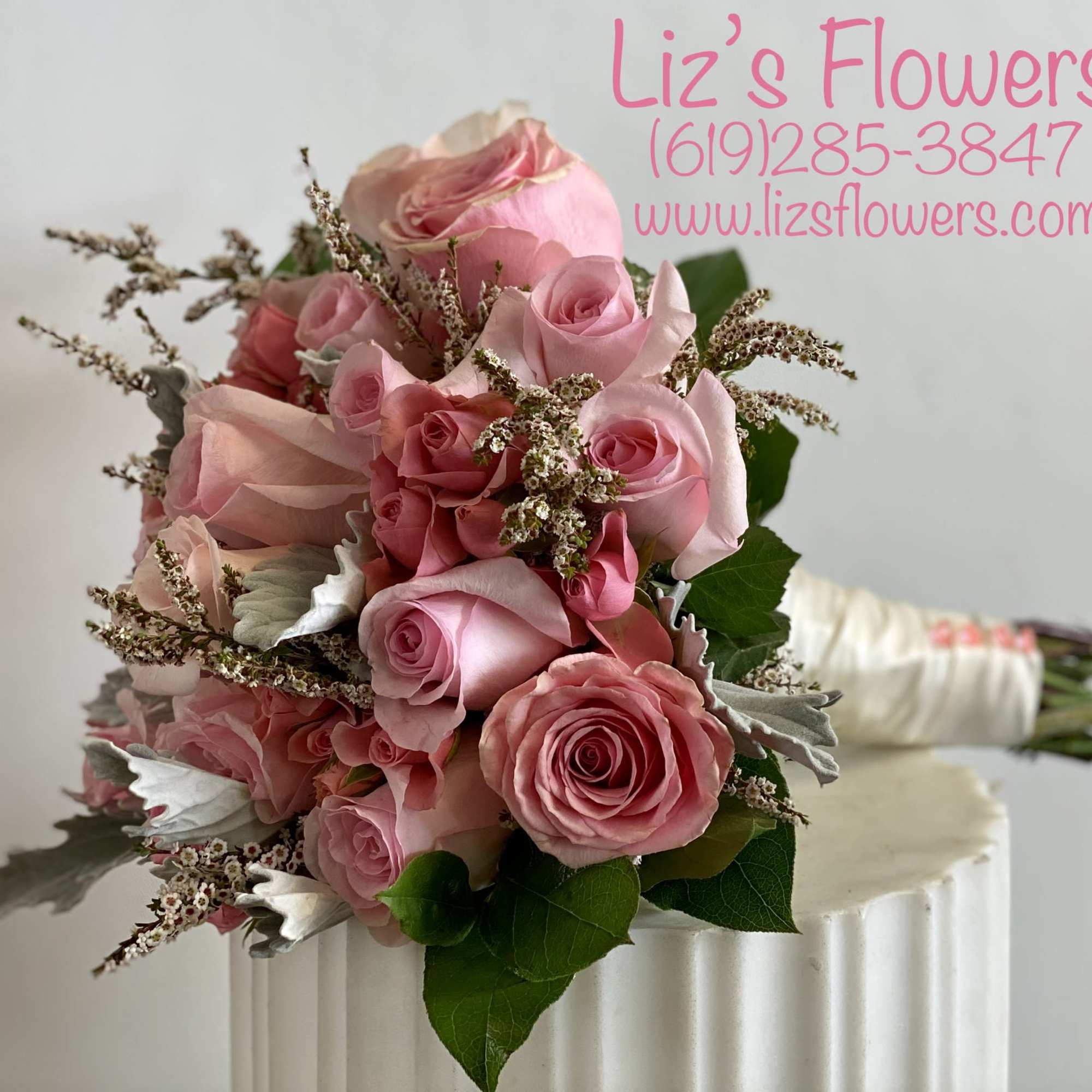 Pink rose bouquet with small filler flowers and green leaves