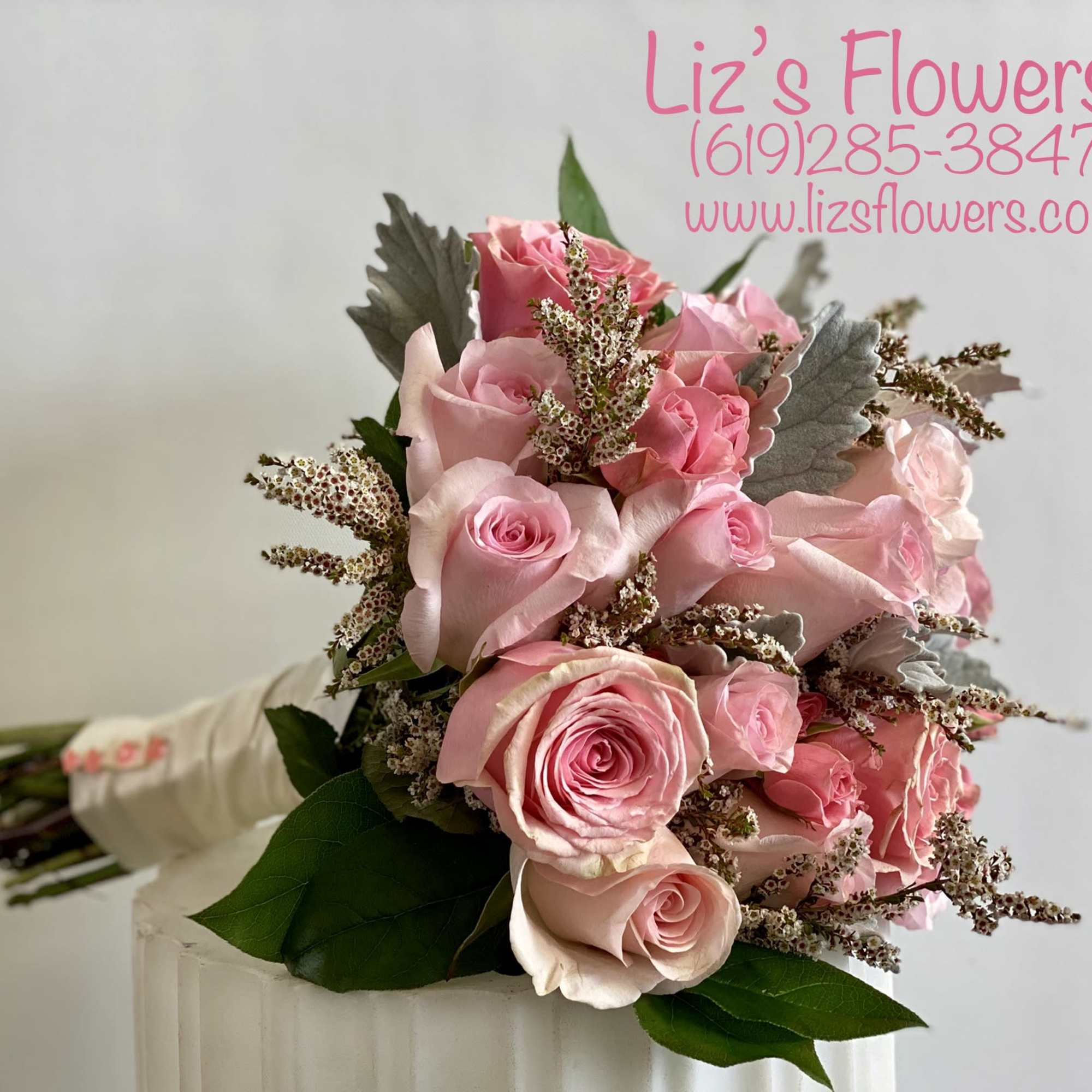 Bouquet of pink roses with filler flowers and greenery