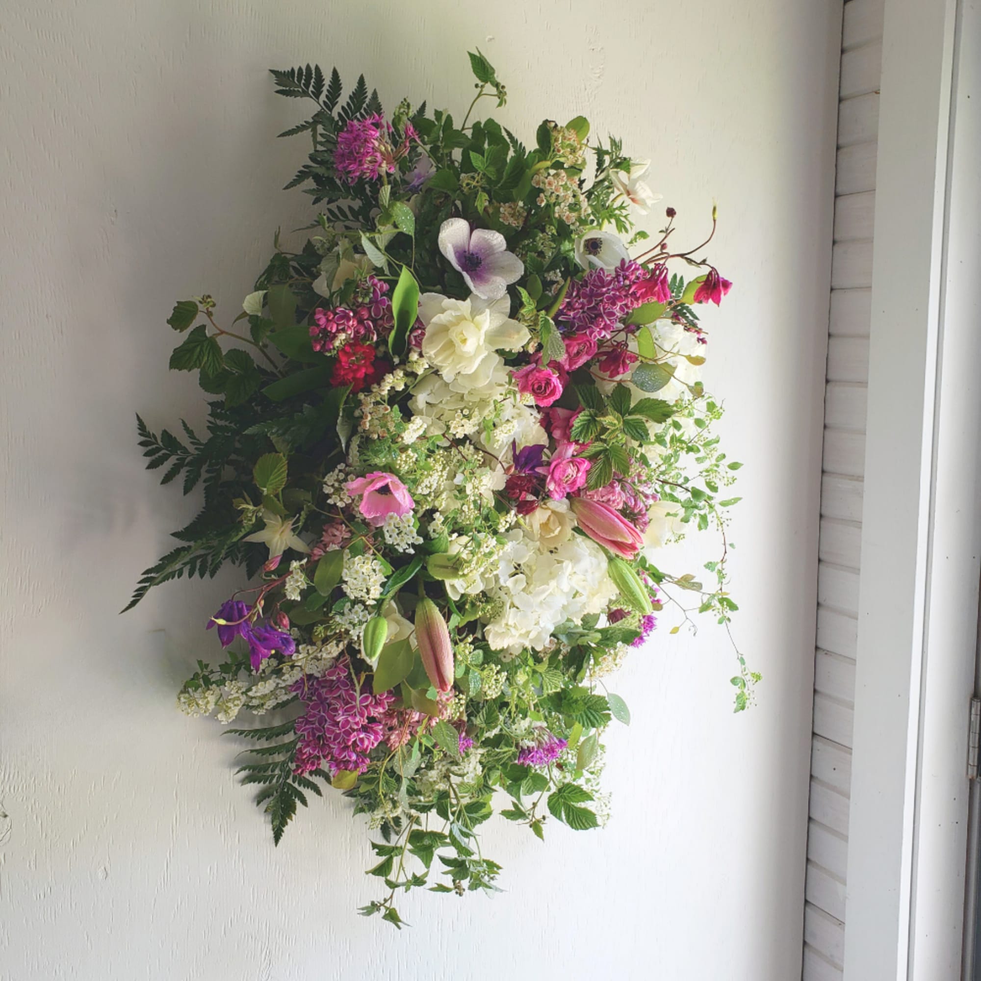 Large mixed floral arrangement with pink, white, and purple blooms