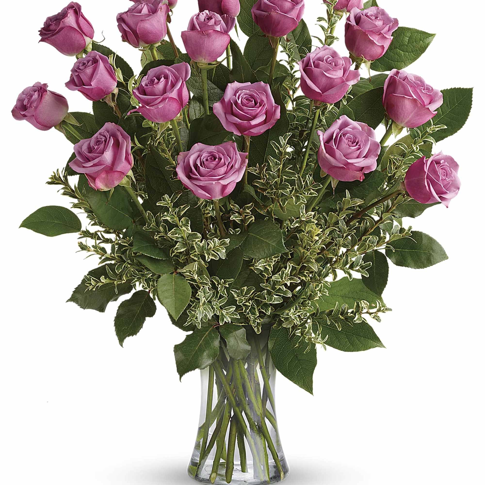 Pink roses arranged in a clear glass vase with greenery