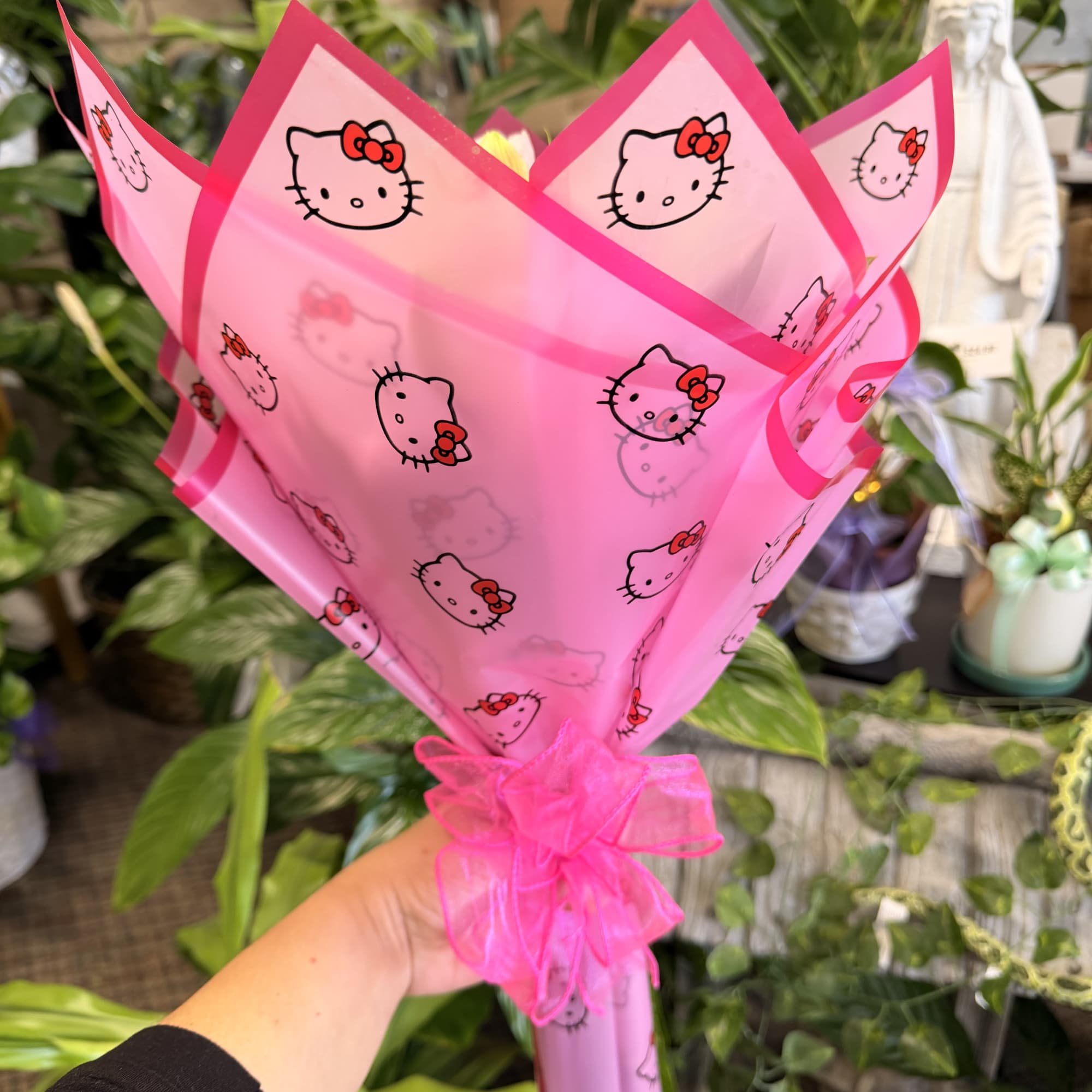 Pink Hello Kitty wrapping with a ribbon around a bouquet