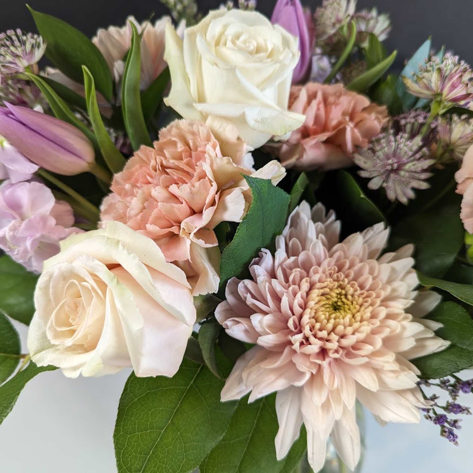 Bouquet of cream roses, blush carnations, and pale pink chrysanthemums