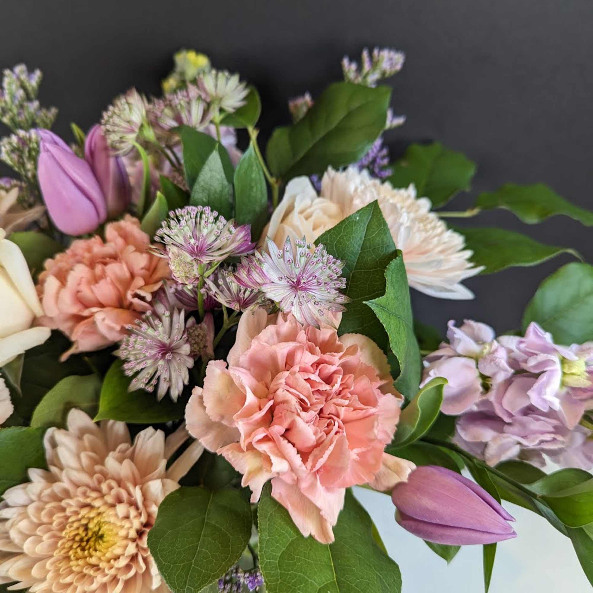 Pastel bouquet with tulips, carnations, and daisy-like blooms