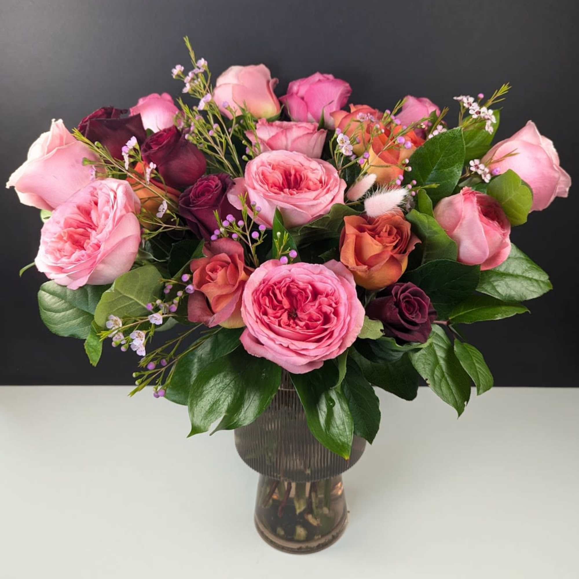Bouquet of pink and burgundy roses in a glass vase