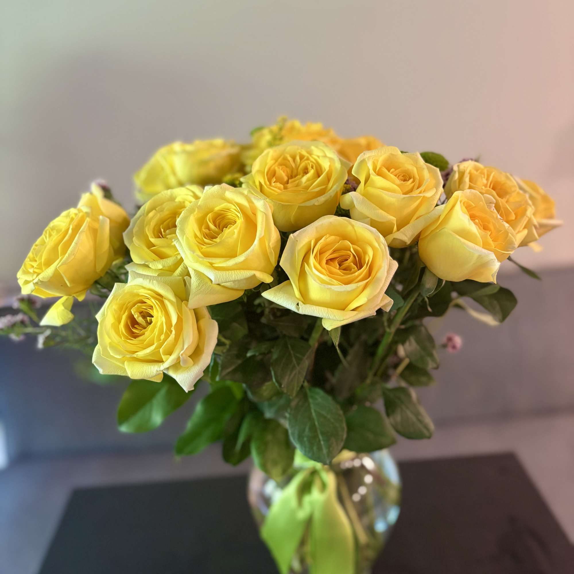 Yellow roses arranged in a clear glass vase