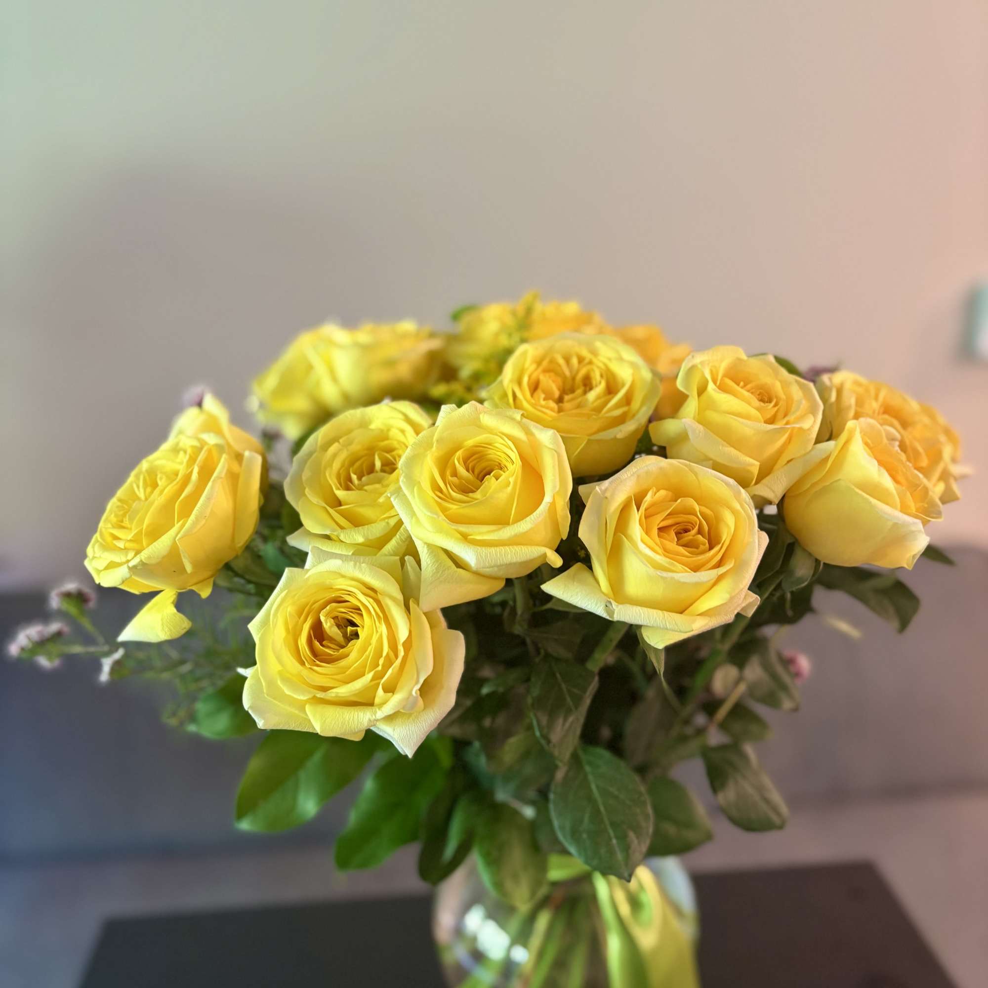 Bouquet of yellow roses in a glass vase