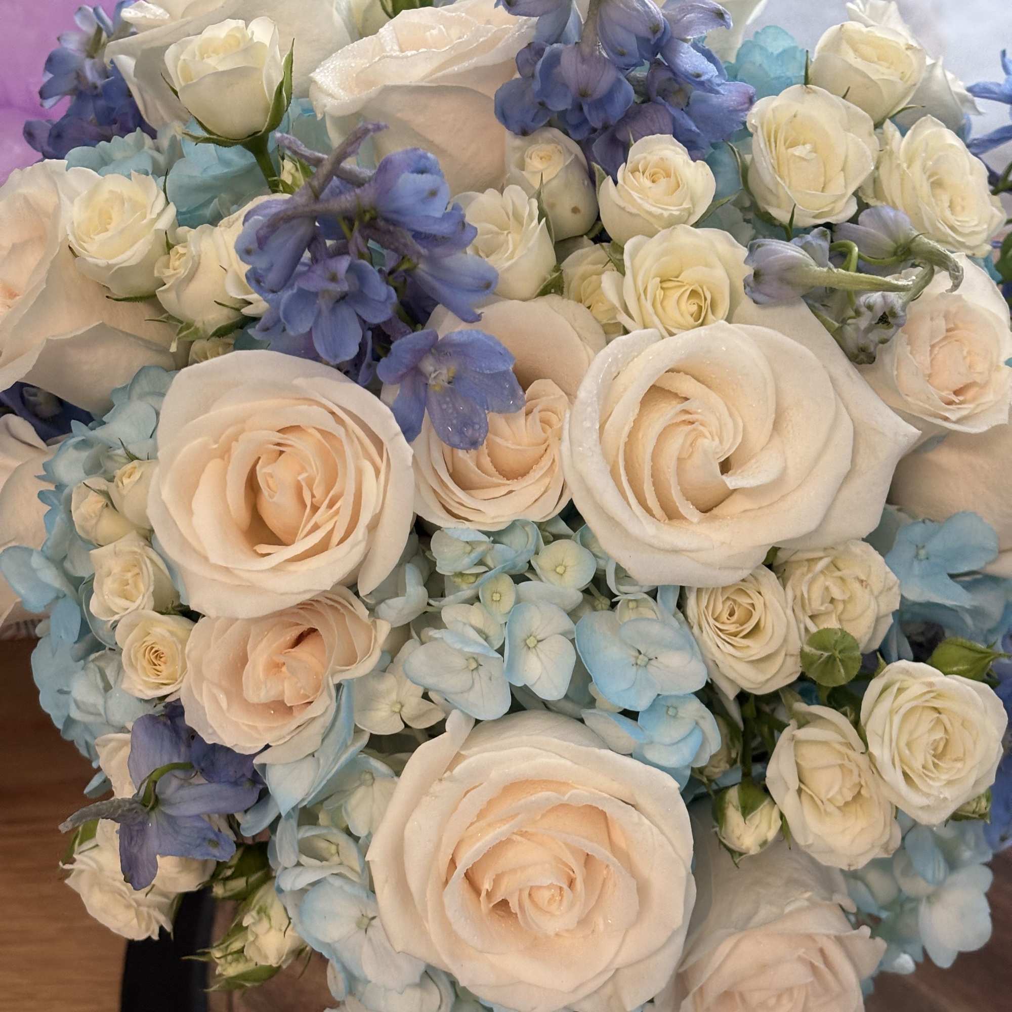 Bouquet of cream roses and blue flowers