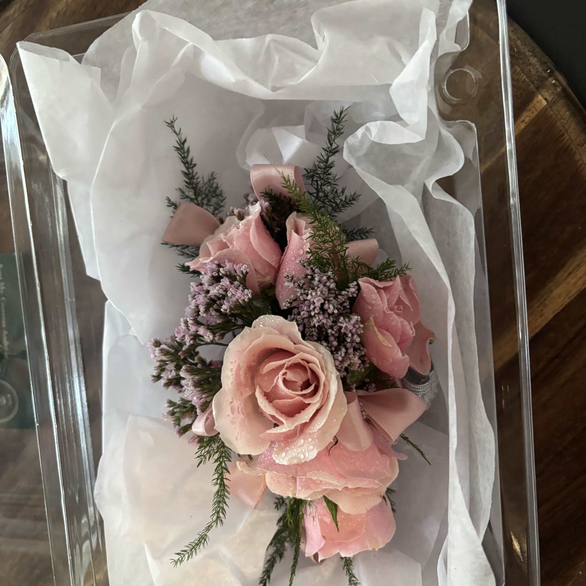 Pink rose corsage in a clear gift box with white tissue