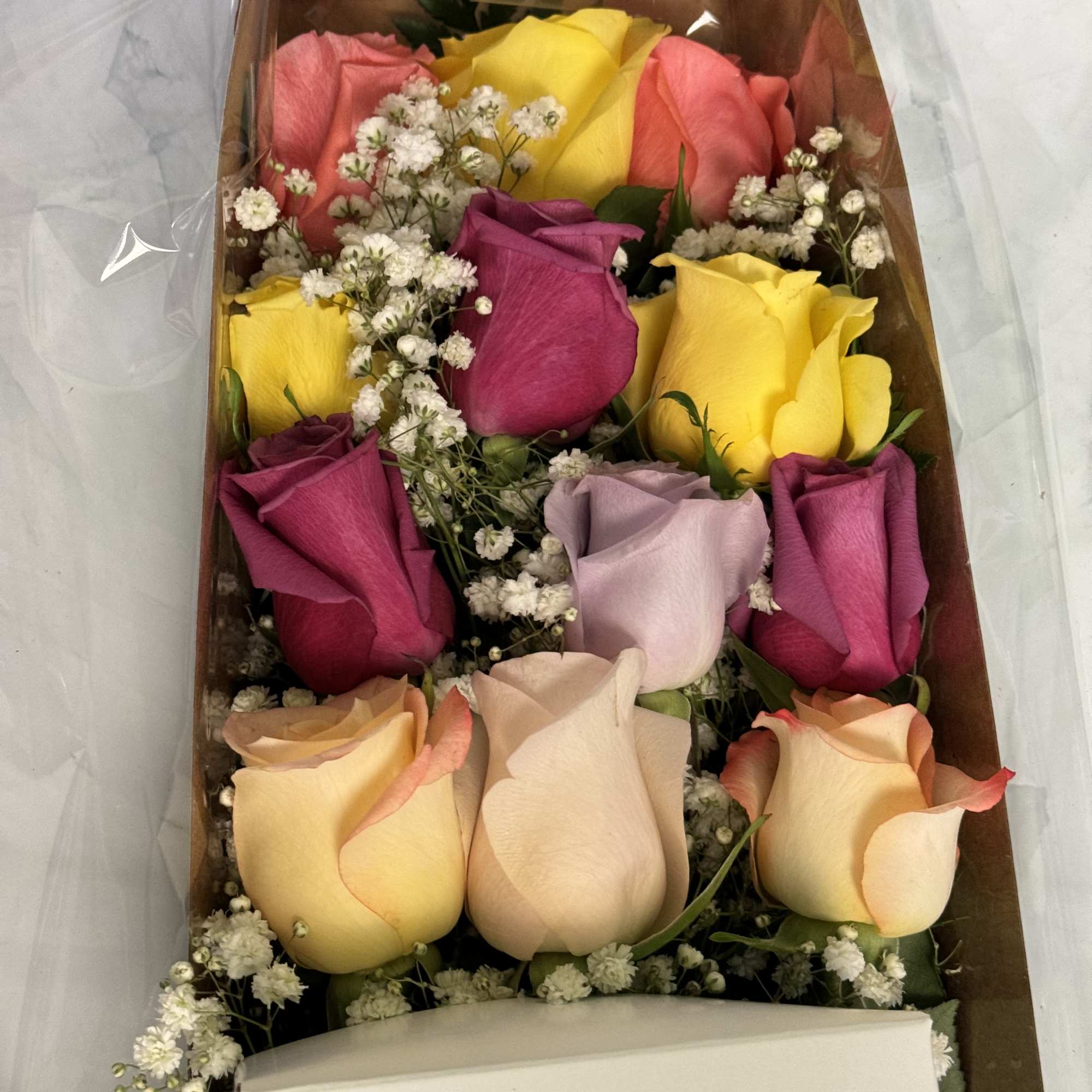 Boxed bouquet of multicolored roses with baby's breath
