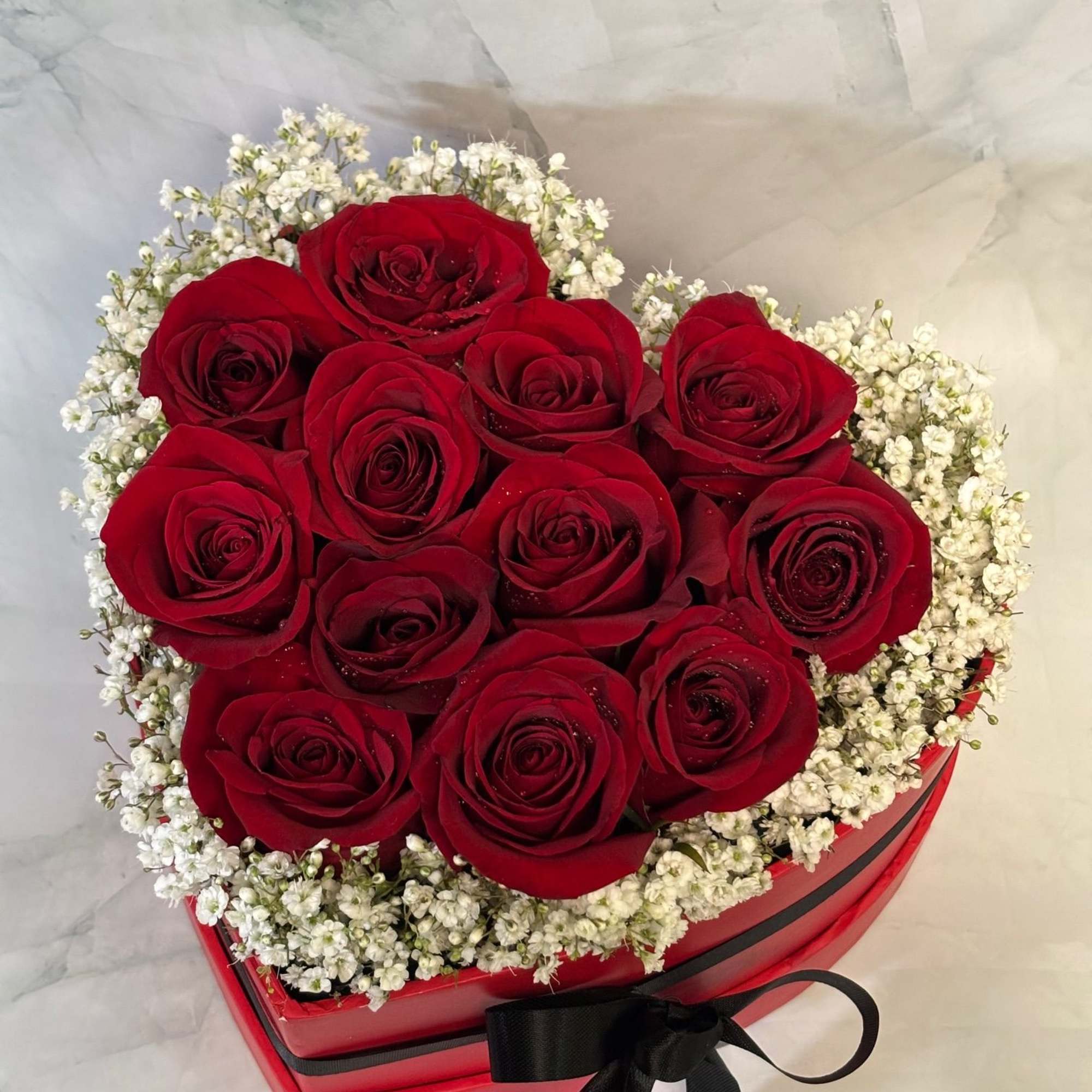This arrangement is full of 12 fresh red roses that are designed