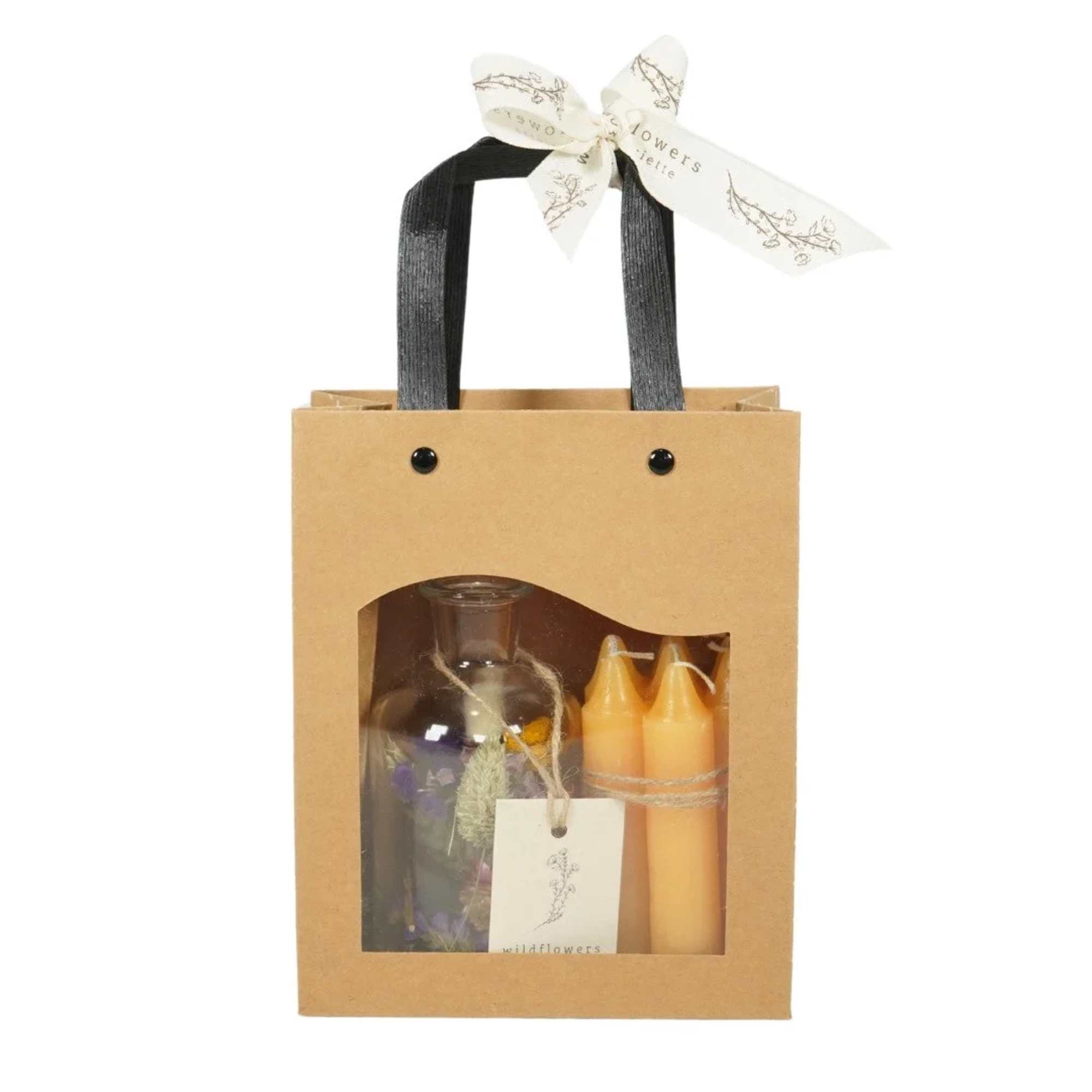 Gift bag with a glass bottle and two candles inside