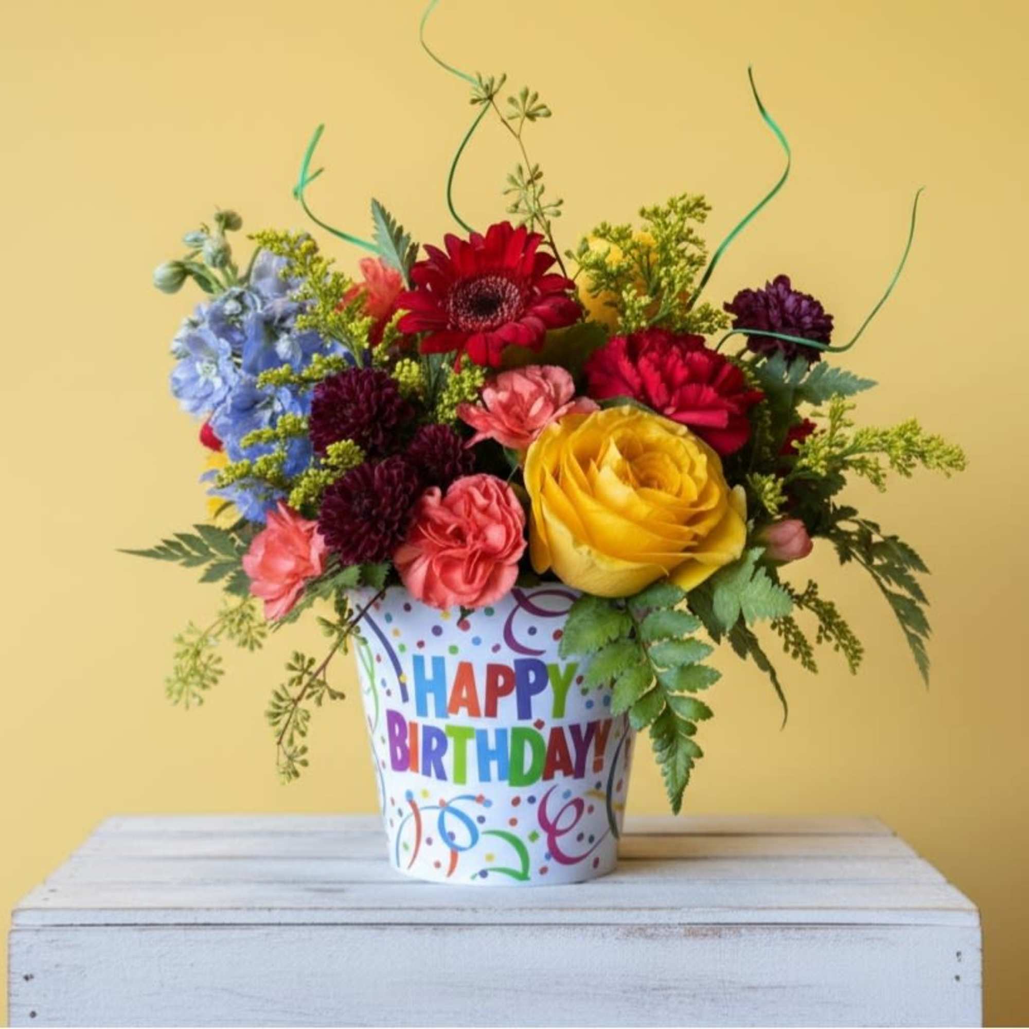  The arrangement features a diverse mix of flowers, each contributing to