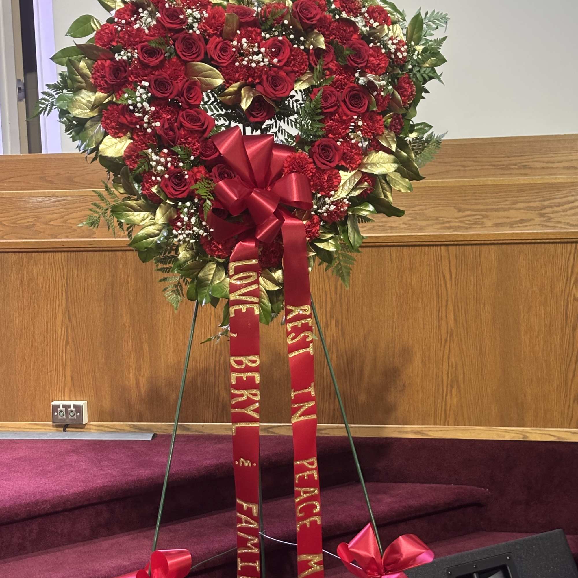 Heart-shaped red rose wreath on an easel with red ribbons, photo 2 of 4