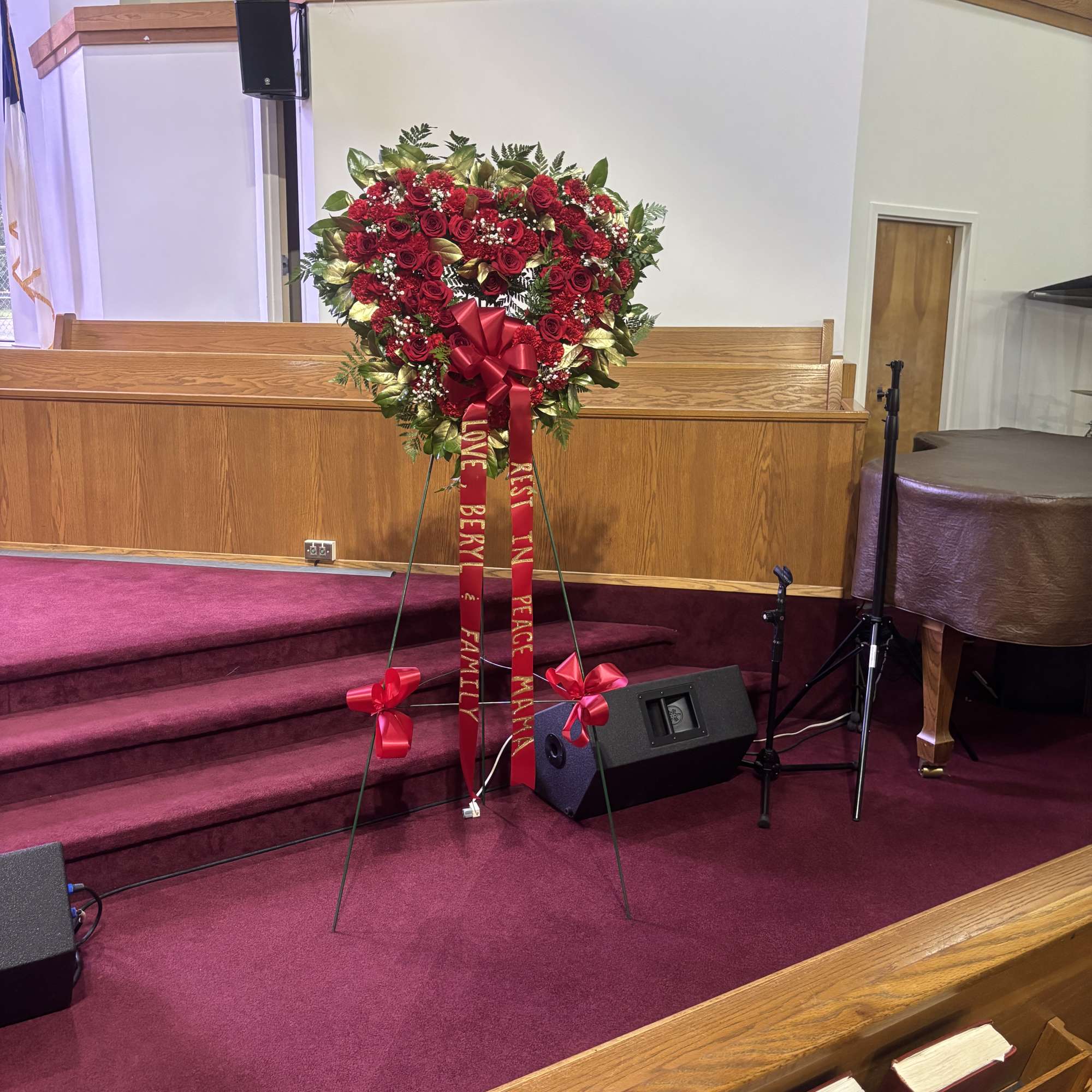 Heart-shaped red rose wreath on an easel with red ribbons, photo 3 of 4