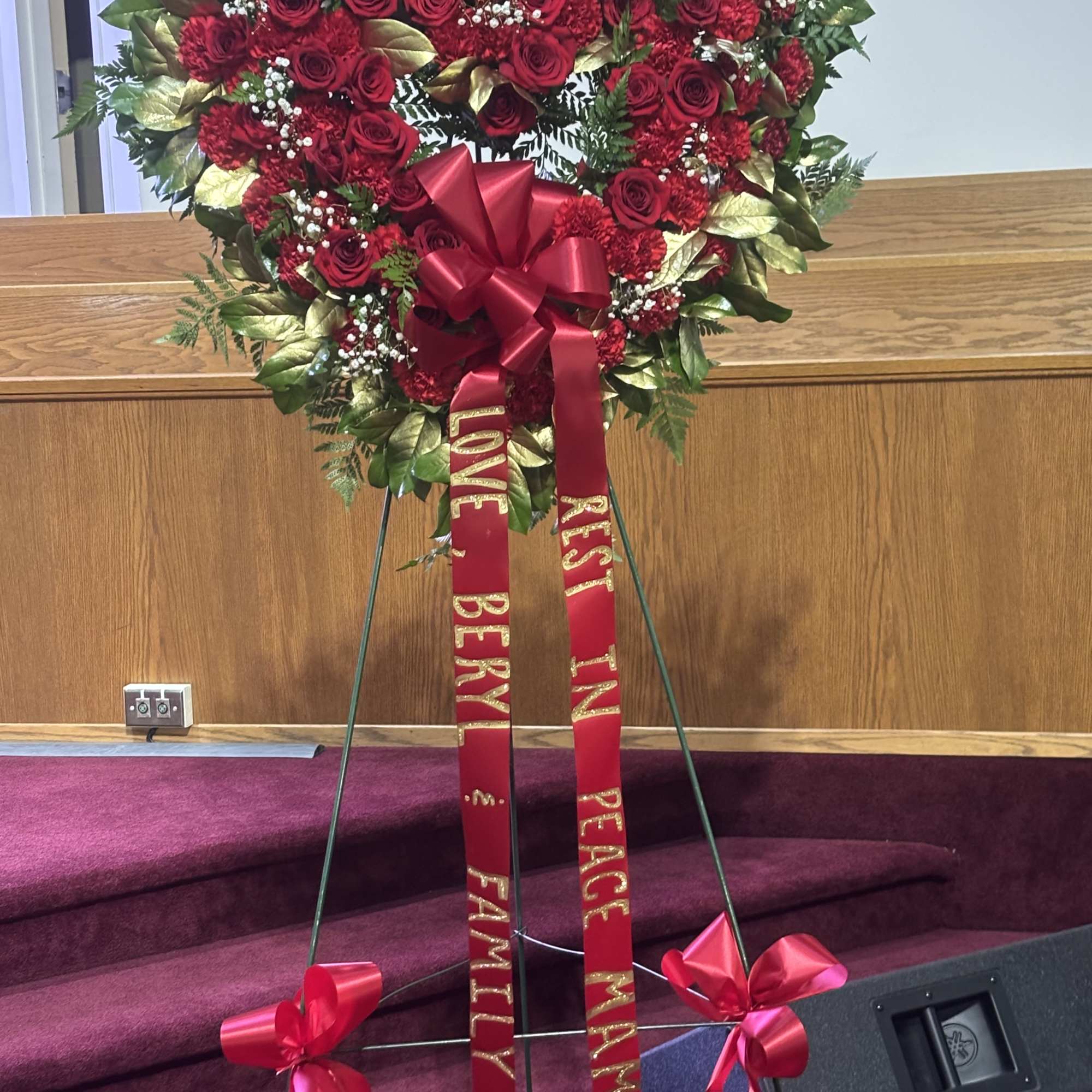 Heart-shaped red rose wreath on an easel with red ribbons, photo 4 of 4