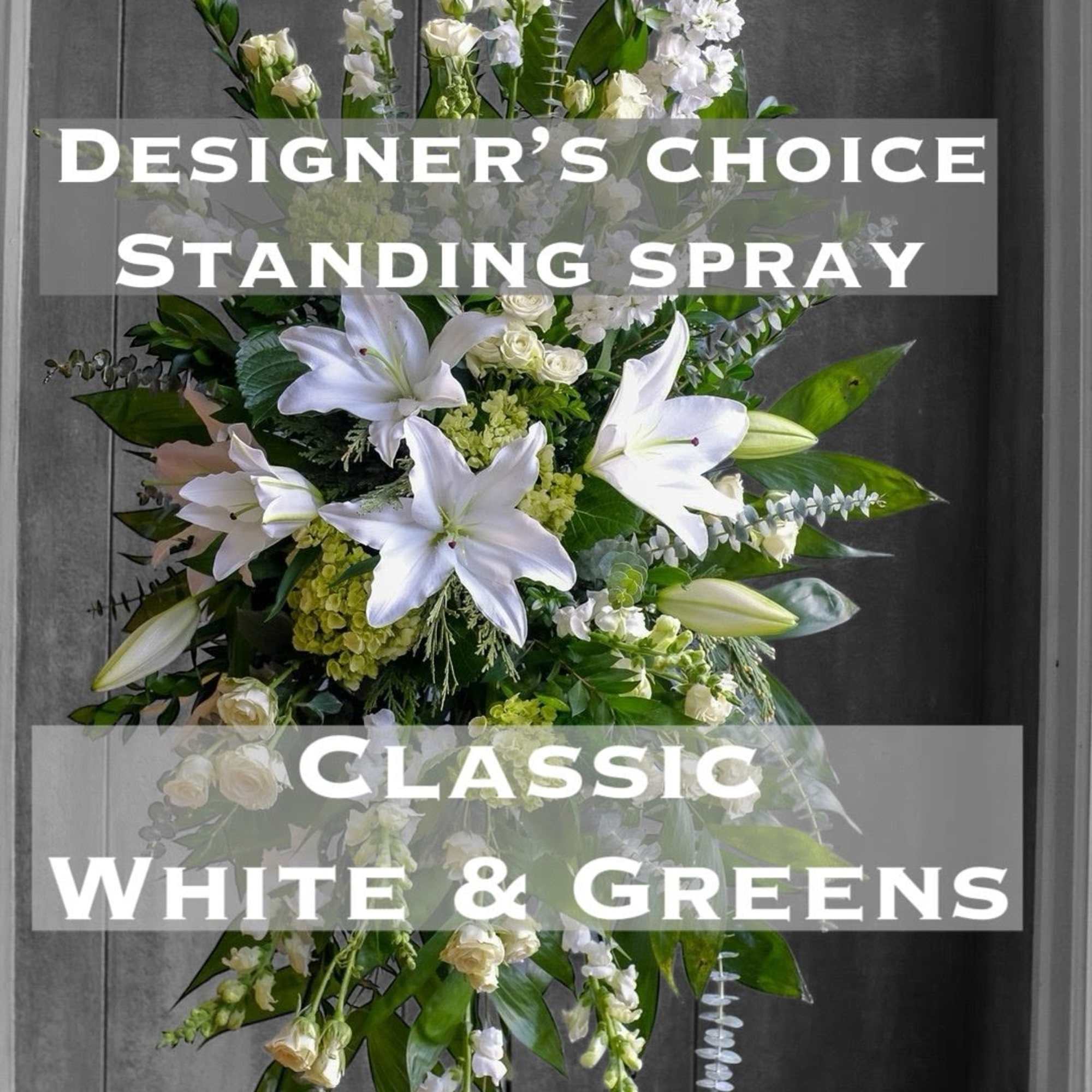 White and green standing spray with lilies and roses on a stand