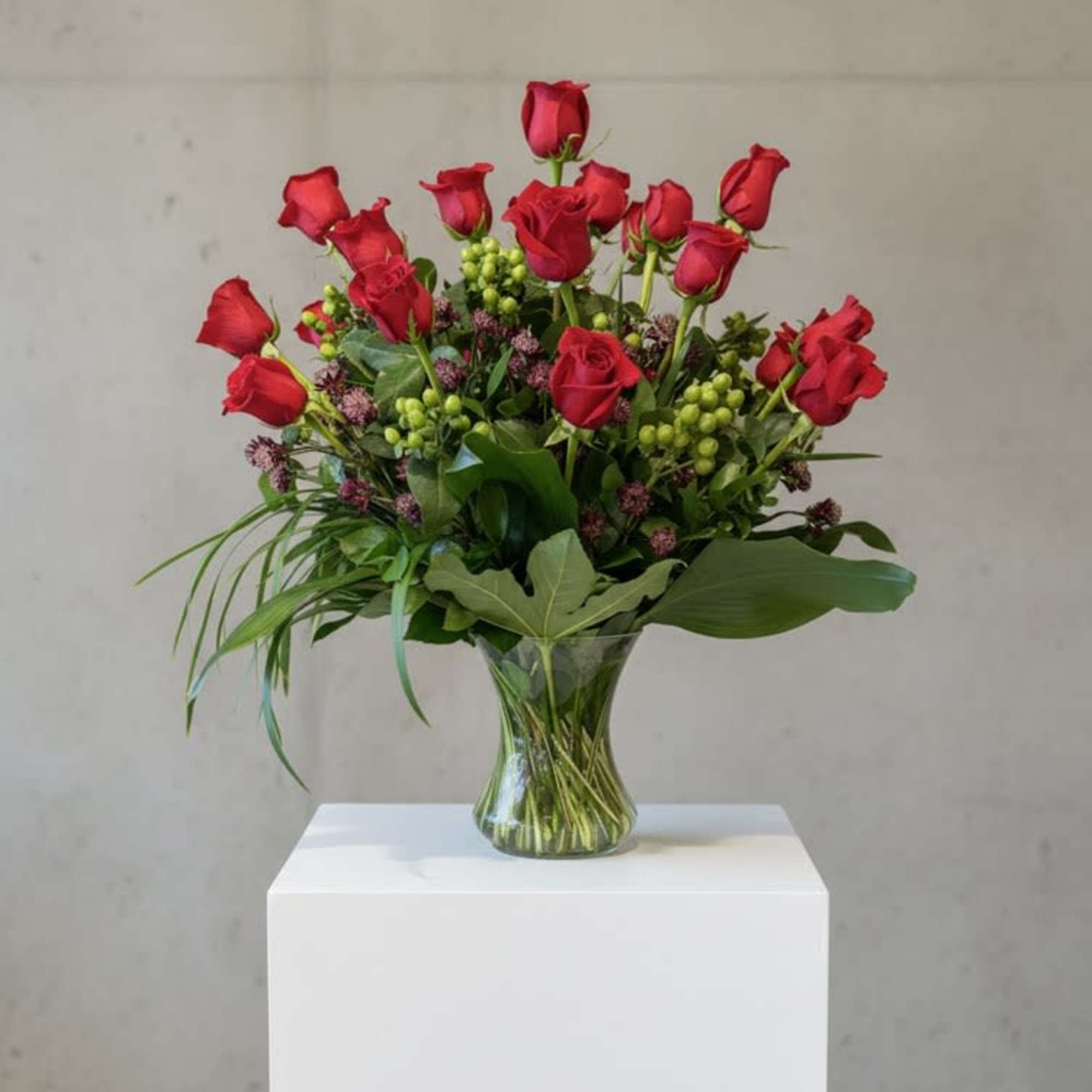 Bountiful roses with a variety of greens and floral accents.. a generous