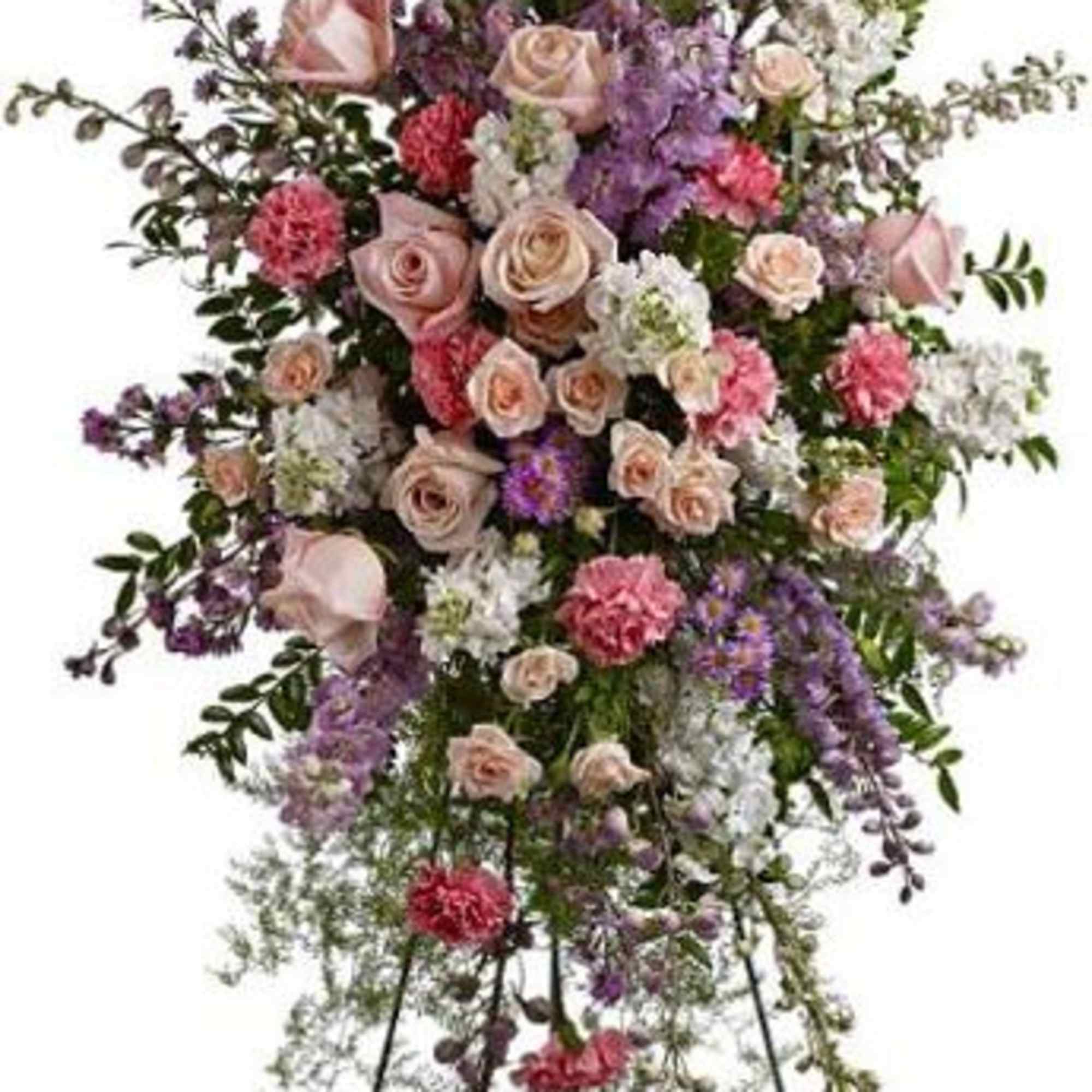 Tall standing floral spray with pink roses and purple flowers on a metal easel