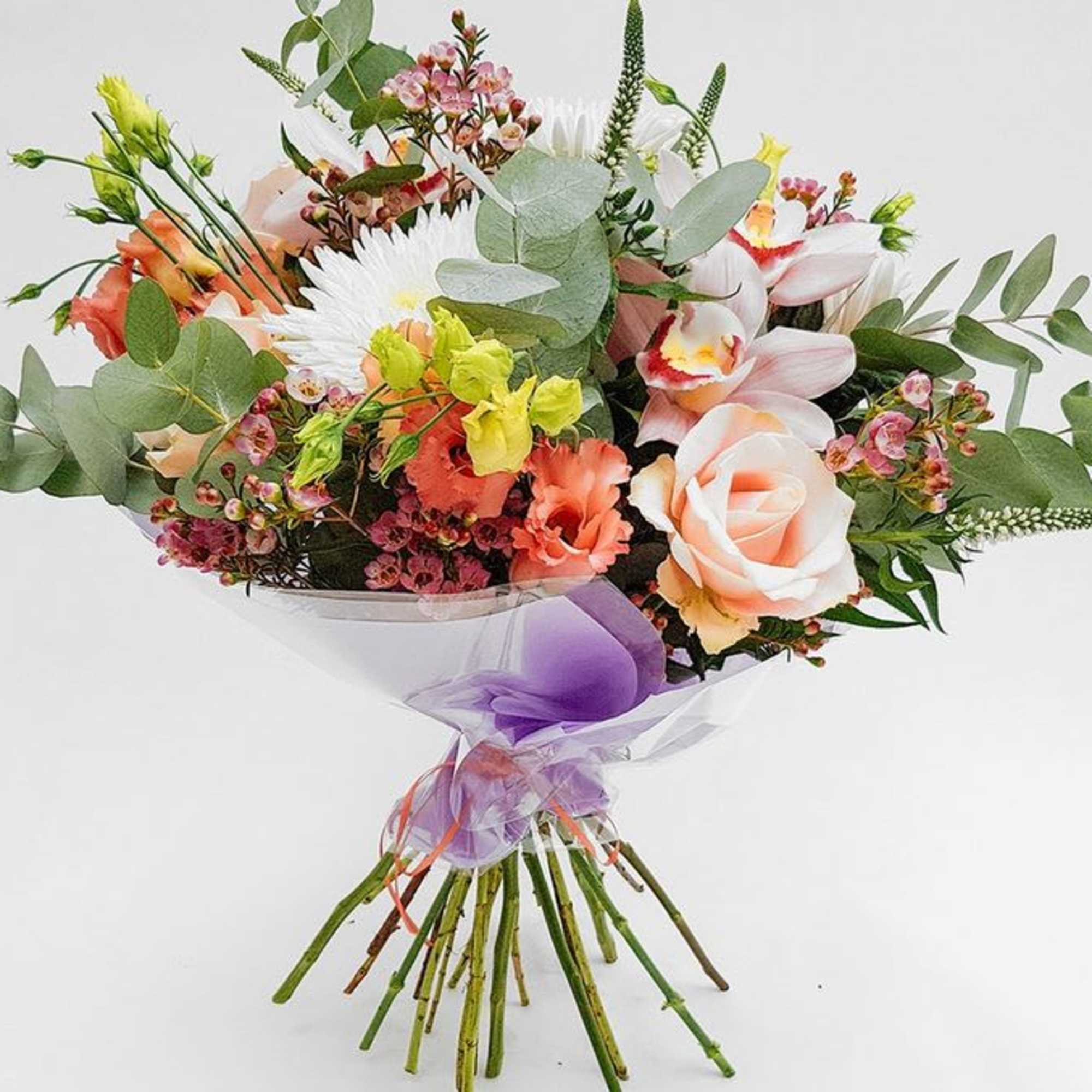 Mixed bouquet with roses, orchids, and daisies wrapped in purple ribbon