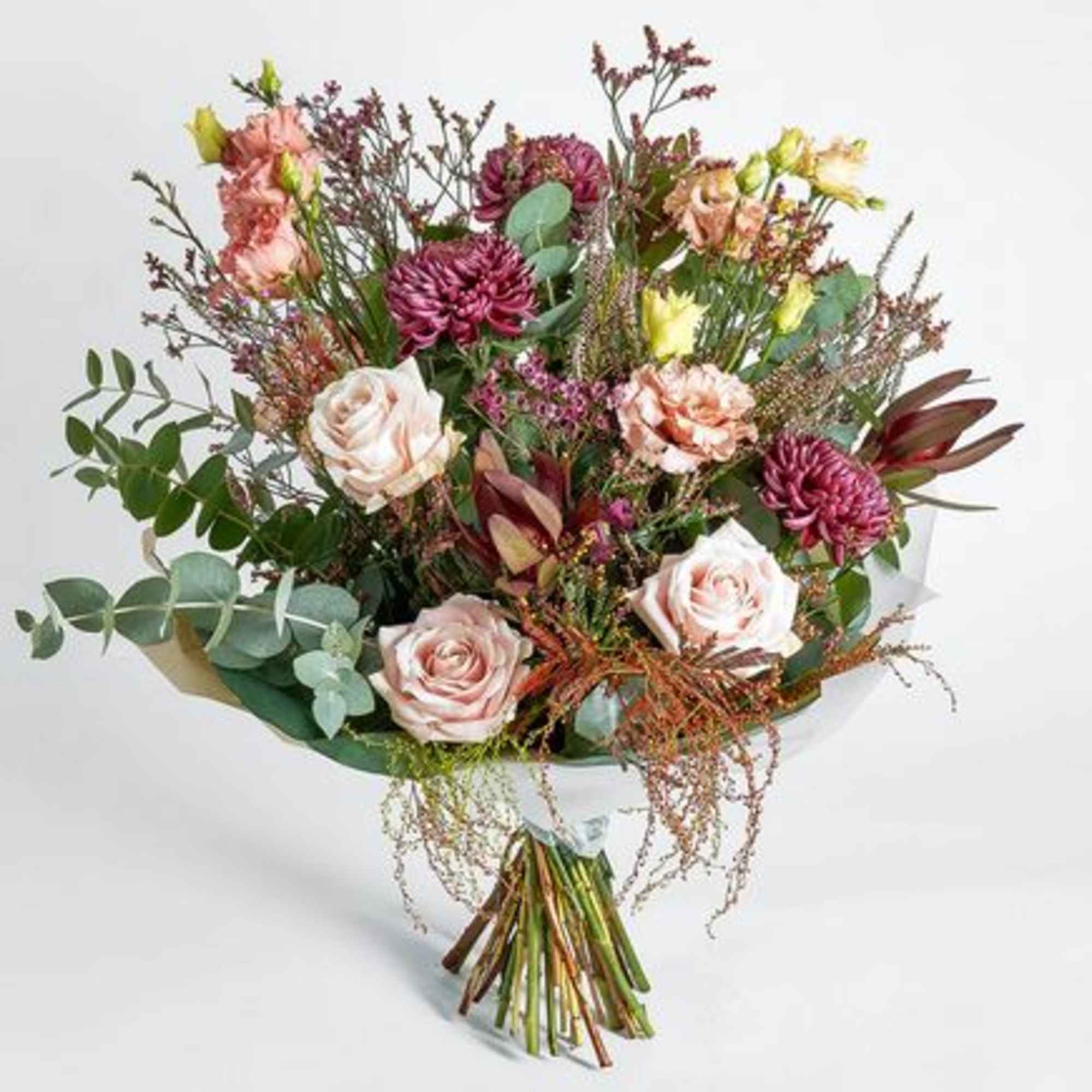 Mixed bouquet of pink roses and purple blooms with eucalyptus